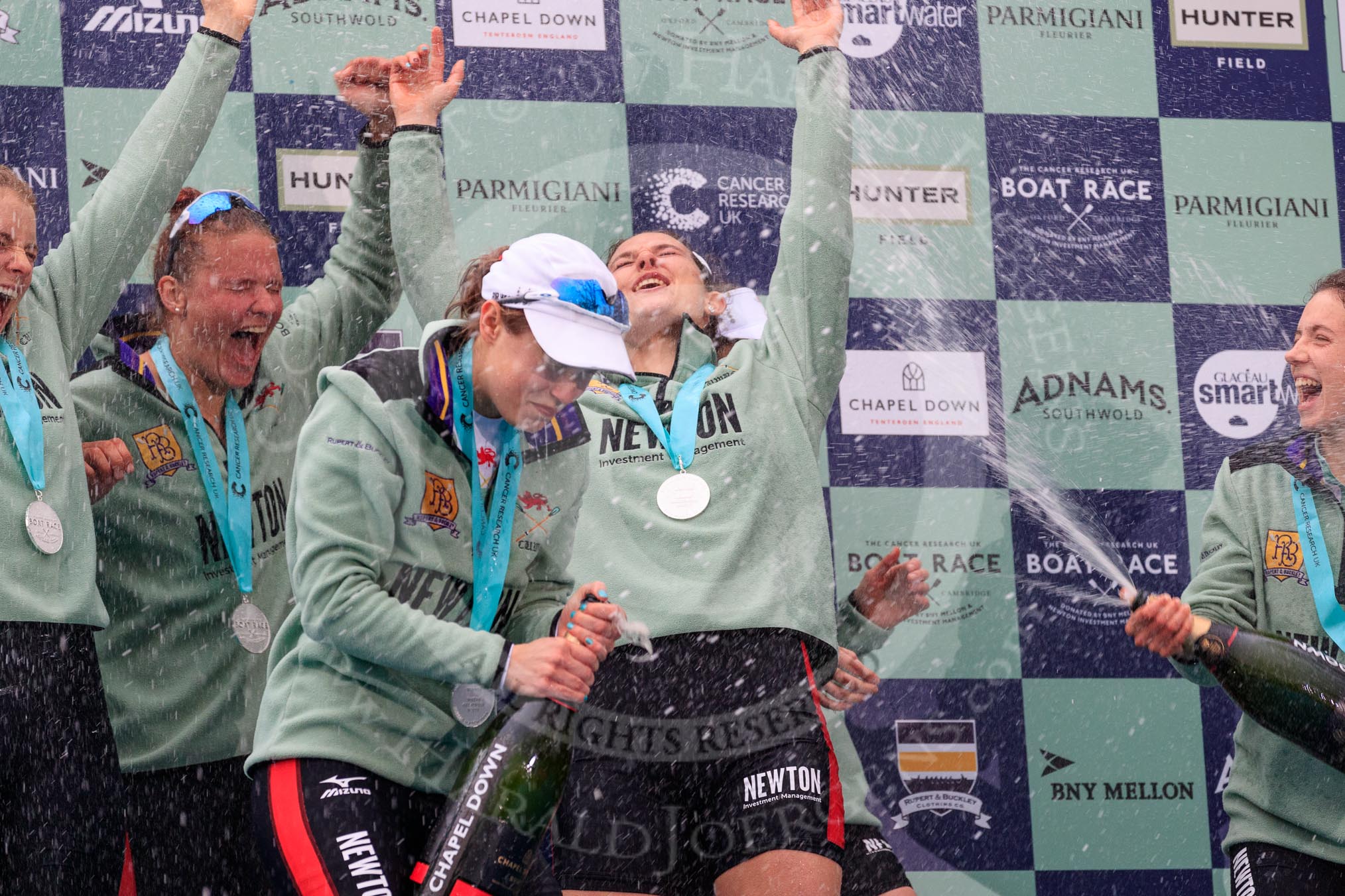 The Cancer Research UK Women's Boat Race 2018: Cambridge victory celebrations and lots of Chapel Down Brut sprayed all over the rowers, here Alice White, Paula Wesselmann, Sophie Shapter, Myriam Goudet-Boukhatmi, and Imogen Grant.
River Thames between Putney Bridge and Mortlake,
London SW15,

United Kingdom,
on 24 March 2018 at 17:09, image #284
