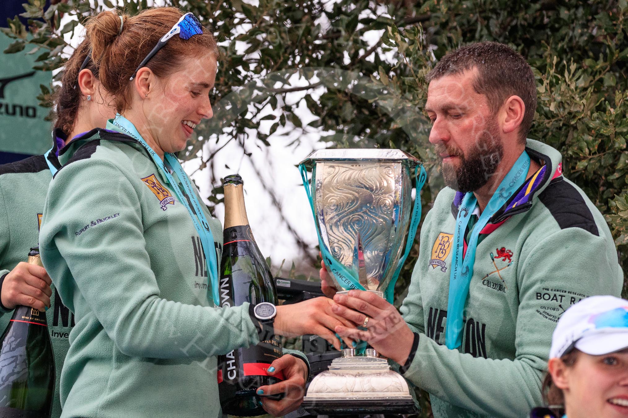 The Cancer Research UK Women's Boat Race 2018: Cambridge 6 seat Alice White with the Women's Boat Race trophy, a bottle of Chapel Down Brut, and Cambridge Head Coach Rob Baker.
River Thames between Putney Bridge and Mortlake,
London SW15,

United Kingdom,
on 24 March 2018 at 17:10, image #305