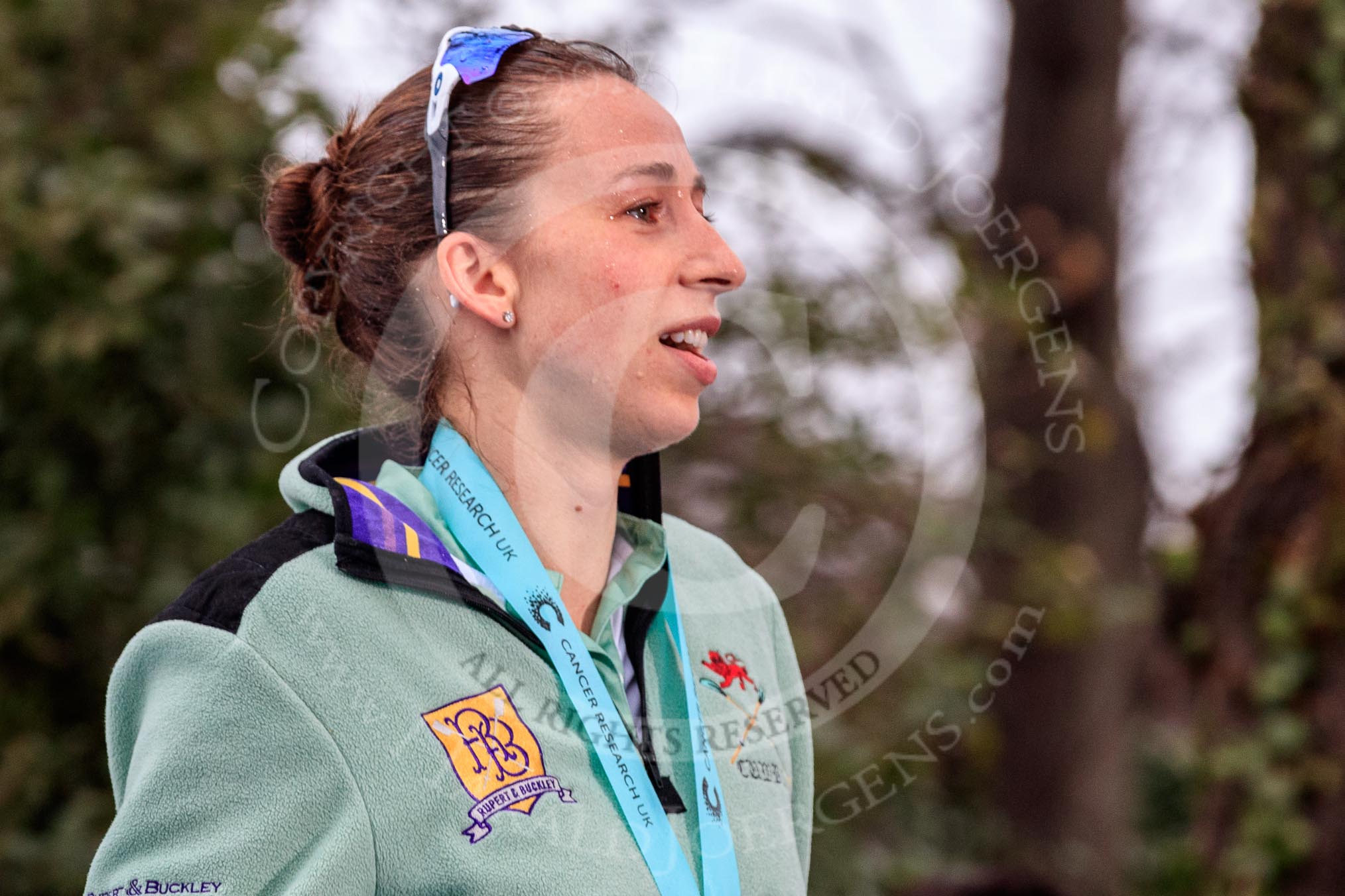 The Cancer Research UK Women's Boat Race 2018: Cambridge stroke Olivia Coffey  leaving the podium, still wet from the champagne that had been sprayed.
River Thames between Putney Bridge and Mortlake,
London SW15,

United Kingdom,
on 24 March 2018 at 17:10, image #306