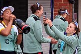 The Cancer Research UK Women's Boat Race 2018: Cambridge president Daphne Martschenko after the official ceremony, celebrating with a bottle of Chapel Down Brut, and Alice White taking photos of her.
River Thames between Putney Bridge and Mortlake,
London SW15,

United Kingdom,
on 24 March 2018 at 17:16, image #325