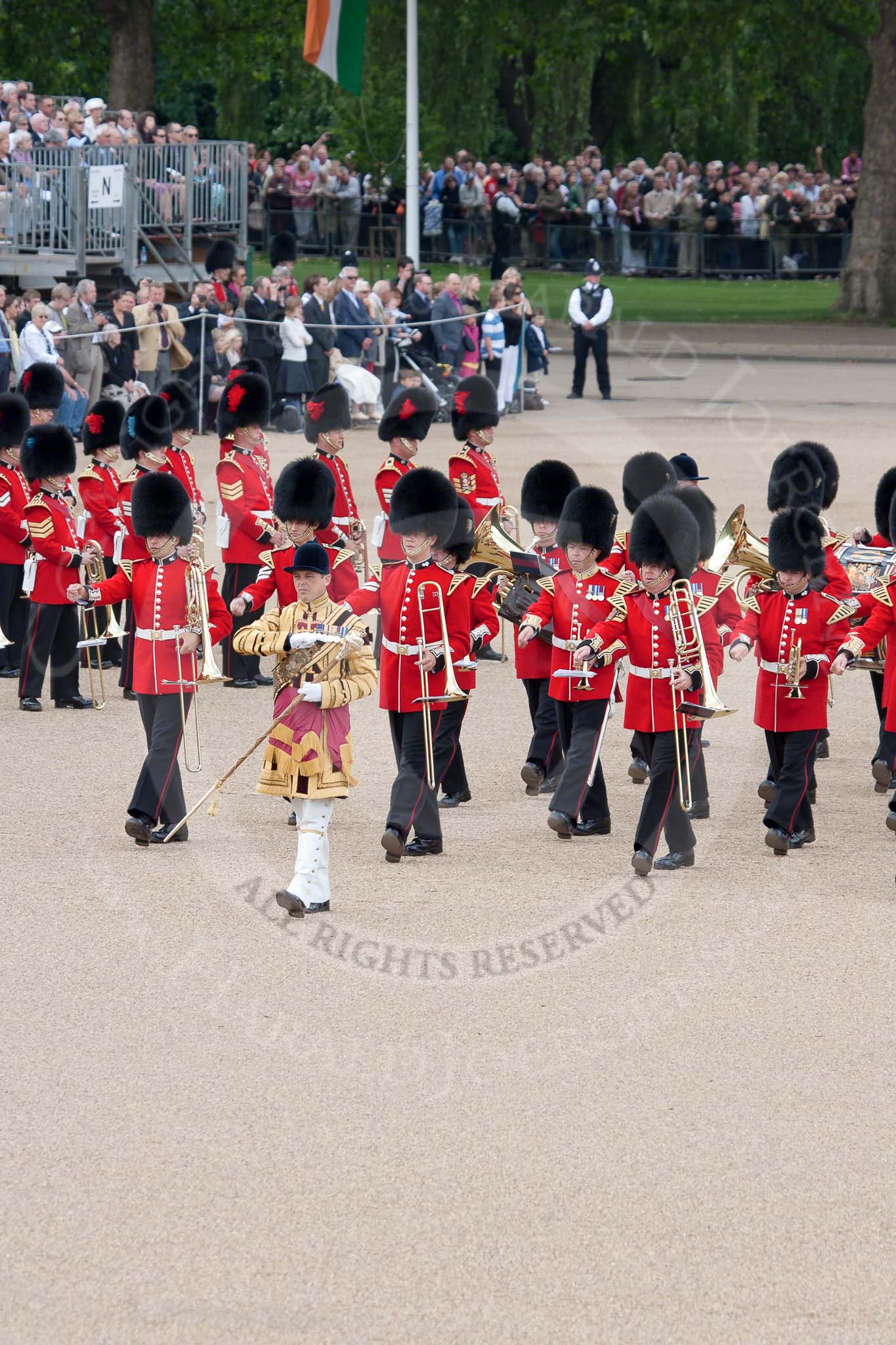 Trooping the Colour 2010: Thirty minutes before the start of the parade. The Band of the Grenadier Guards is led onto the parade ground by their Drum Major.

Already in position, with the red plumes on the bearskin, the Band of the Coldstream Guards.

In the background spectators watching from St. James's Park, on the western side of Horse Guards Parade.

The spectators on the top left of the photo are at the back of the garden of No. 10 Downing Street,.
Horse Guards Parade, Westminster,
London SW1,
Greater London,
United Kingdom,
on 12 June 2010 at 10:31, image #16