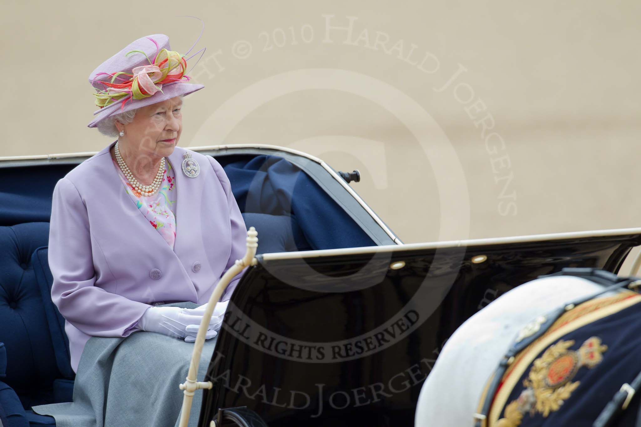 Trooping the Colour 2010: Her Majesty The Queen, sitting in her Ivory Monted Phaeton,  inspecting the line of soldiers on the parade ground..
Horse Guards Parade, Westminster,
London SW1,
Greater London,
United Kingdom,
on 12 June 2010 at 11:06, image #97