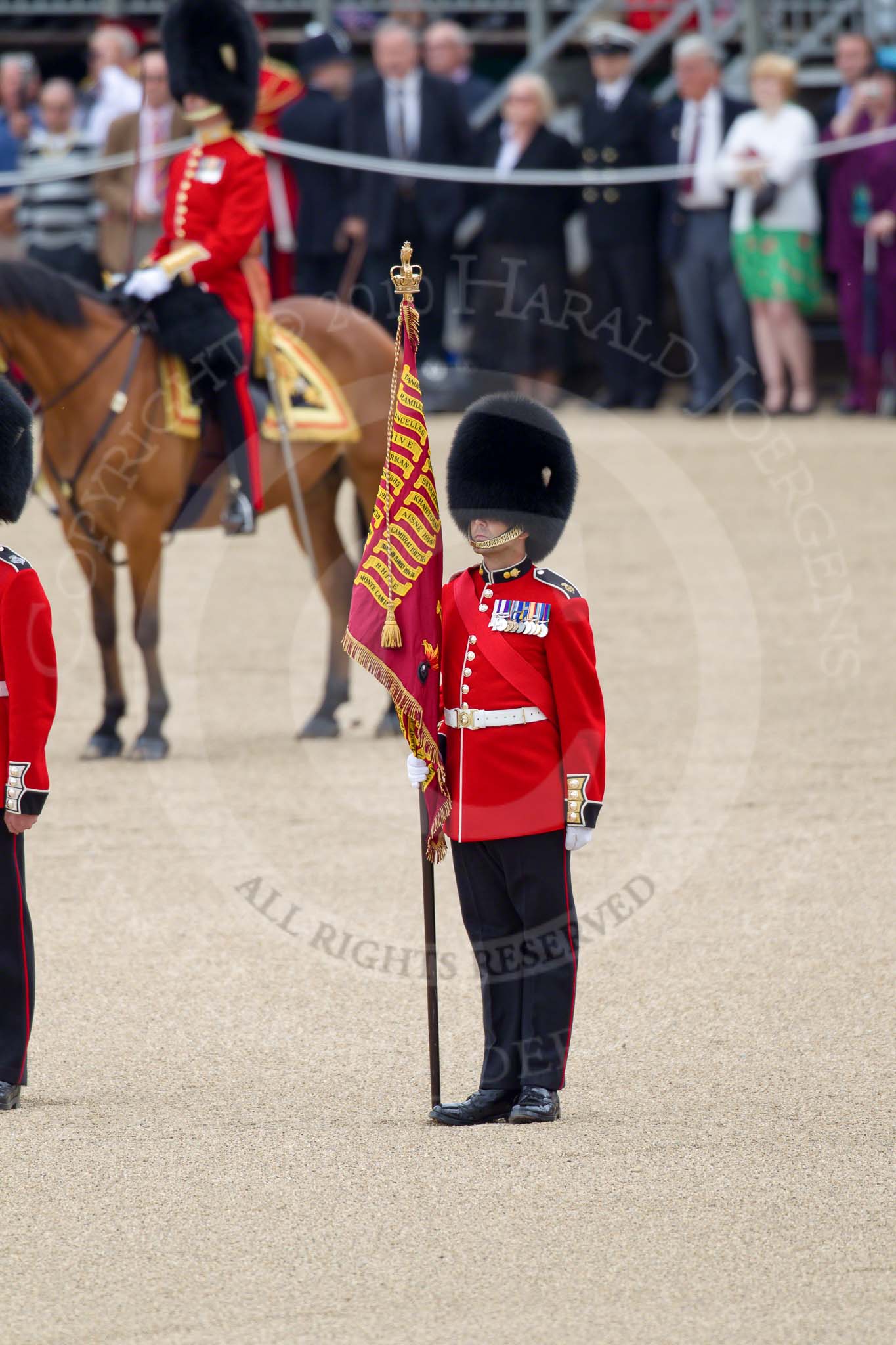 Trooping the Colour 2010: Colour Sergeant Stephen Ross, who was awarded the Military Cross in 2006, with the just uncased Colour.

In the background spectators at the inner line of sentries in front of the Old Admirality Building..
Horse Guards Parade, Westminster,
London SW1,
Greater London,
United Kingdom,
on 12 June 2010 at 11:10, image #106
