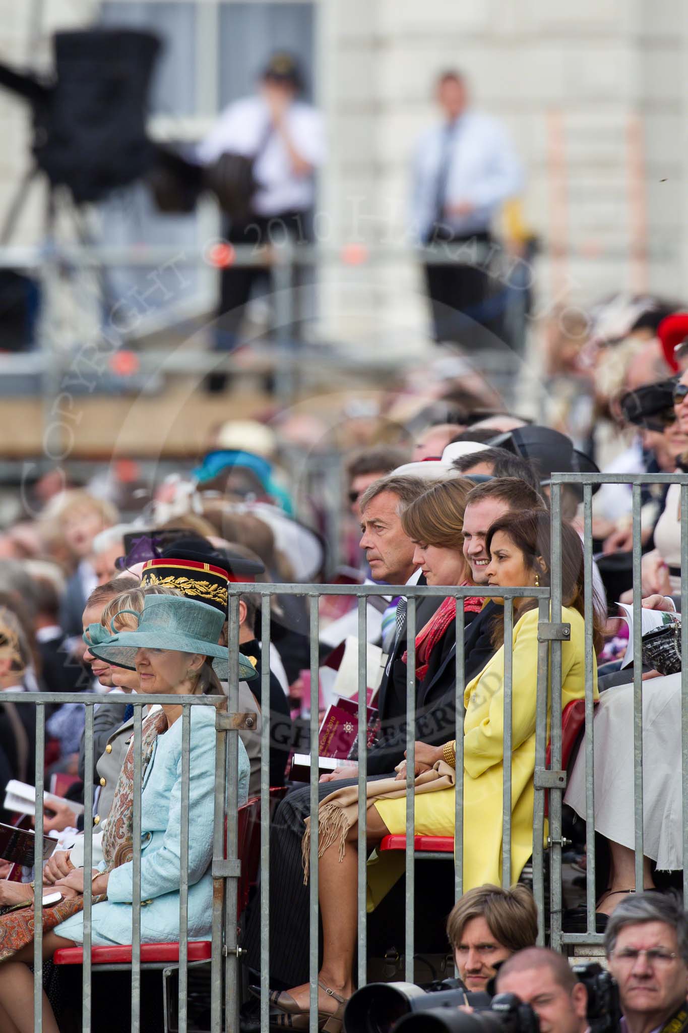 Photo HJoergens41_100612_G6C7445 Trooping the Colour 2010: Spectators watchin the March Past by the Foot Guards, sitting on a stand on the eastern side of the parae ground. On top of the photo a television crew, at the bottom press photographers..
Horse Guards Parade, Westminster,
London SW1,
Greater London,
United Kingdom,
on 12 June 2010 at 11:44, image #154