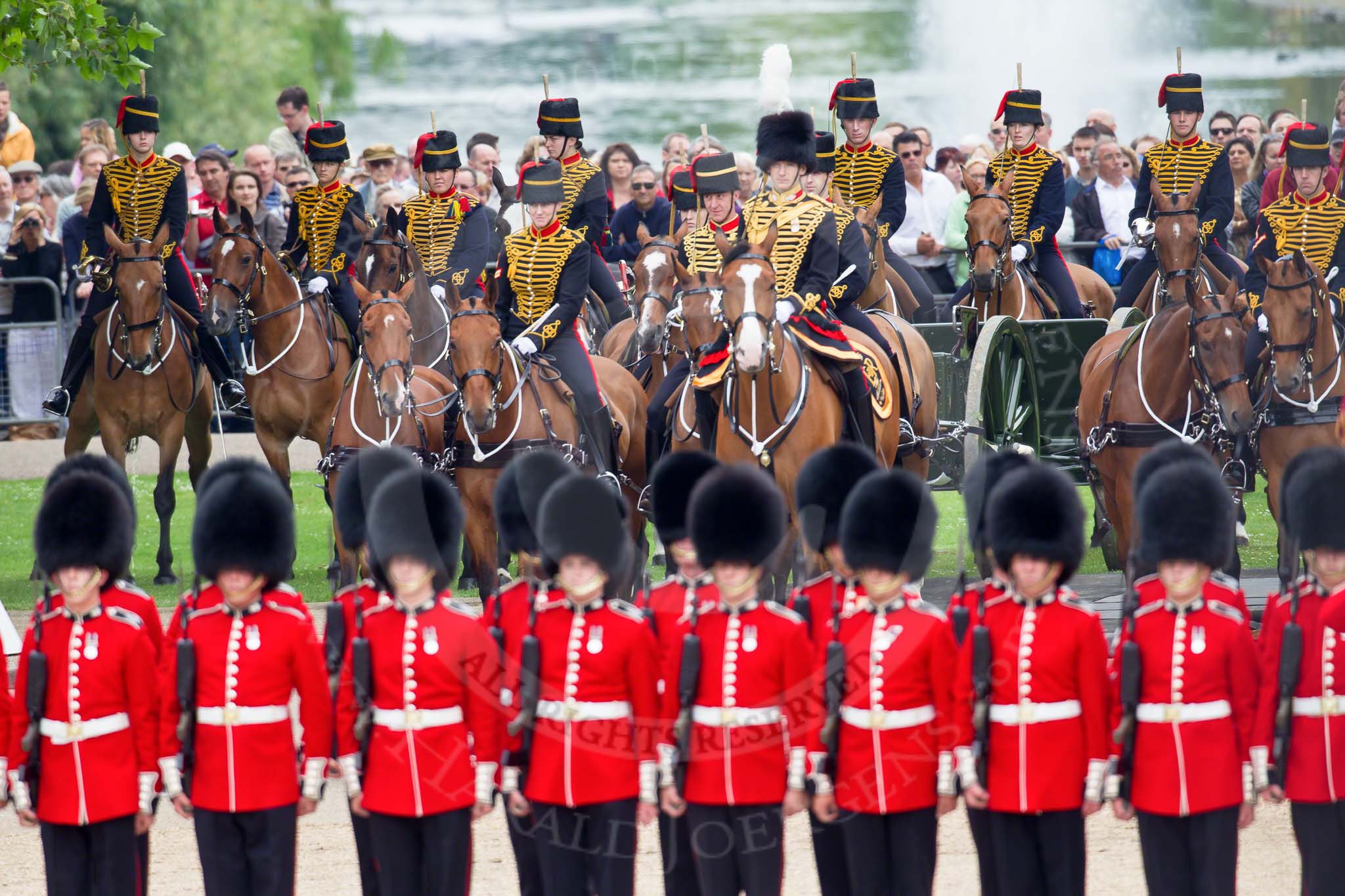 Photo HJoergens41_100612_G6C7512 Trooping the Colour 2010: Behind No. 1 Guard, 1st Battalion Grenadier Guards, and in front of spectators watching from St. James's Park, with a lake and fountain in the background, is The King's Troop Royal Horse Artillery, with their horses and 13-pounder state saluting guns..
Horse Guards Parade, Westminster,
London SW1,
Greater London,
United Kingdom,
on 12 June 2010 at 11:51, image #160