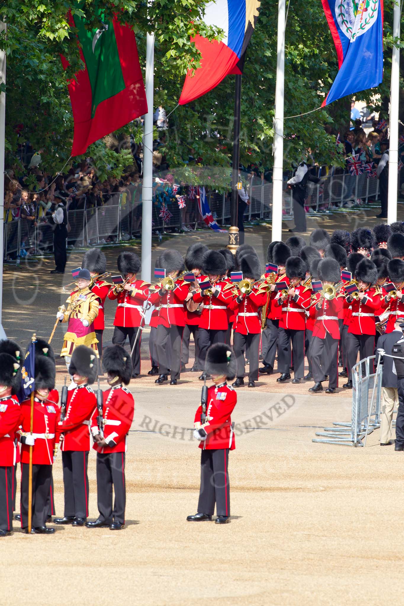 The Colonel's Review 2011: Drum Major Alan Harvey, leading the Band of the Scots Guards onto the parade ground. In the background spectators watching from St. James's Park, in the foreground No. 5 Guard, 1st Battalion Welsh Guards..
Horse Guards Parade, Westminster,
London SW1,

United Kingdom,
on 04 June 2011 at 10:29, image #31
