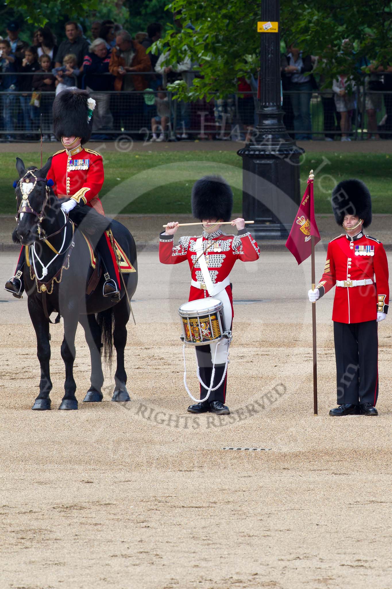 The Colonel's Review 2011: From left to right: Major B P N Ramsay, Welsh Guards, The Major of the Parade, then the 'Lone Drummer', Lance Corporal Gordon Prescott, Scots Guards, and the 'Keeper of the Ground' of No. 1 Guard, 1st Battalion Scots Guards. The Lone Drummer, here saluting, is about to leave the line, marching forward..
Horse Guards Parade, Westminster,
London SW1,

United Kingdom,
on 04 June 2011 at 11:14, image #119