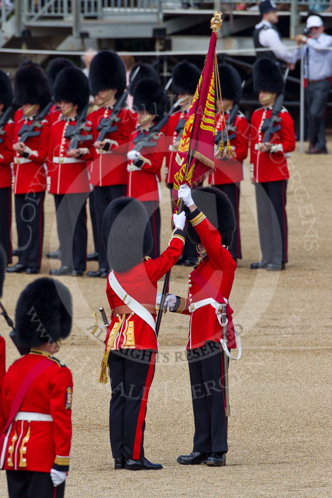 The Colonel's Review 2011: Handing over the Colour. The Regimental Sergeant Major, A I Mackenzie, puts the Colour into the white colour belt of the Ensign, Lieutenant Tom Ogilvy..
Horse Guards Parade, Westminster,
London SW1,

United Kingdom,
on 04 June 2011 at 11:19, image #133