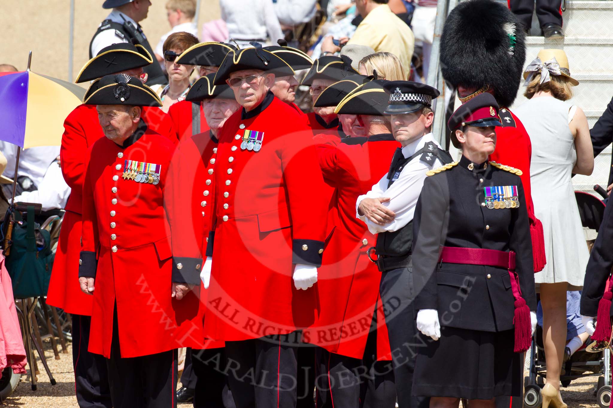 The Colonel's Review 2011: Chelsea Pensioners' (ex-servicemen and -women, in-pensioners living at the Royal Hospital Chelsea), in their scarlet coats and wearing their tricone hats, about to leave at the end of the rehearsal. On the right a captain from the Royal Army Medical Corps..
Horse Guards Parade, Westminster,
London SW1,

United Kingdom,
on 04 June 2011 at 12:13, image #309