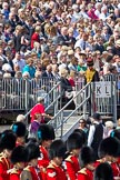 The Colonel's Review 2011: Spectators on a grand stand at the Downing Street side of the parade ground. A member of the Royal Horse Artillery helping spectators to find their seats. In front, the Band of the Irish Guards..
Horse Guards Parade, Westminster,
London SW1,

United Kingdom,
on 04 June 2011 at 10:22, image #20