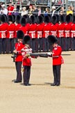 The Colonel's Review 2011: Uncasing the Colour. Colour Sergeant Chris Millin is opening the Colour Case, assisted by the Duty Drummer. Behind the drummer, presenting arms, one of the two sentries..
Horse Guards Parade, Westminster,
London SW1,

United Kingdom,
on 04 June 2011 at 10:33, image #43