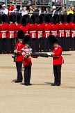 The Colonel's Review 2011: Uncasing the Colour. Colour Sergeant Chris Millin is opening the Colour Case, assisted by the Duty Drummer. Behind the drummer, presenting arms, one of the two sentries..
Horse Guards Parade, Westminster,
London SW1,

United Kingdom,
on 04 June 2011 at 10:33, image #42