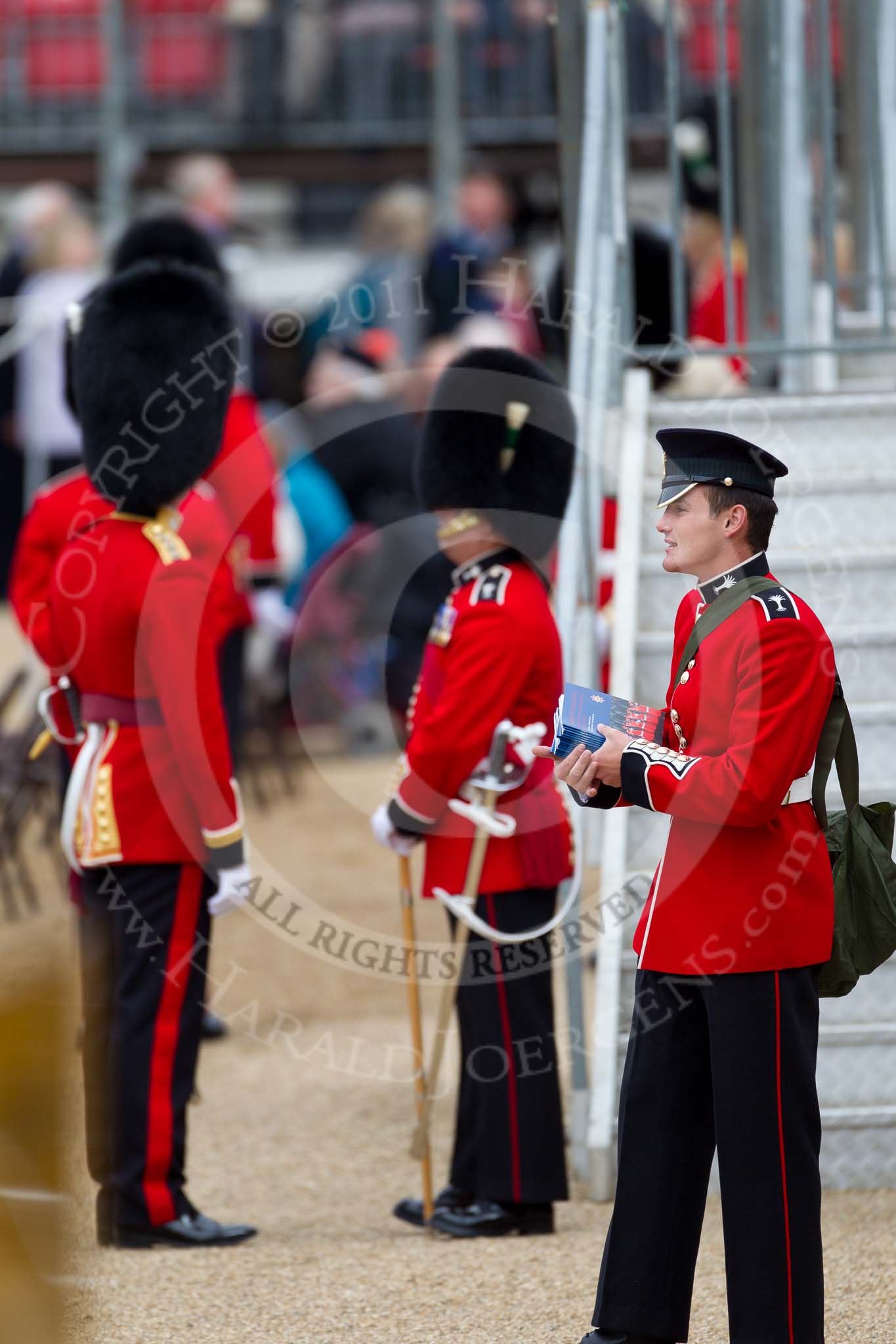 The Major General's Review 2011: Guardsman of the Welsh Guards selling the official programmes of the event to spectators..
Horse Guards Parade, Westminster,
London SW1,
Greater London,
United Kingdom,
on 28 May 2011 at 10:09, image #12