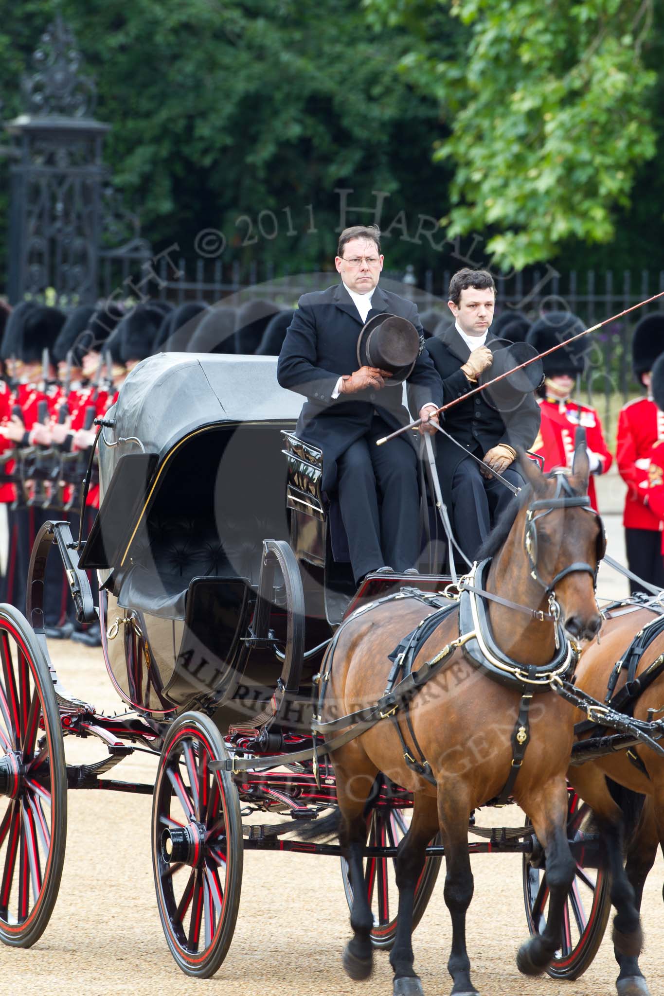 The Major General's Review 2011: The first of the two barouche carriages that would bring members of the Royal Family onto Horse Guards Parade before the Royal Procession. The coachmen are satuting the Colour..
Horse Guards Parade, Westminster,
London SW1,
Greater London,
United Kingdom,
on 28 May 2011 at 10:50, image #86