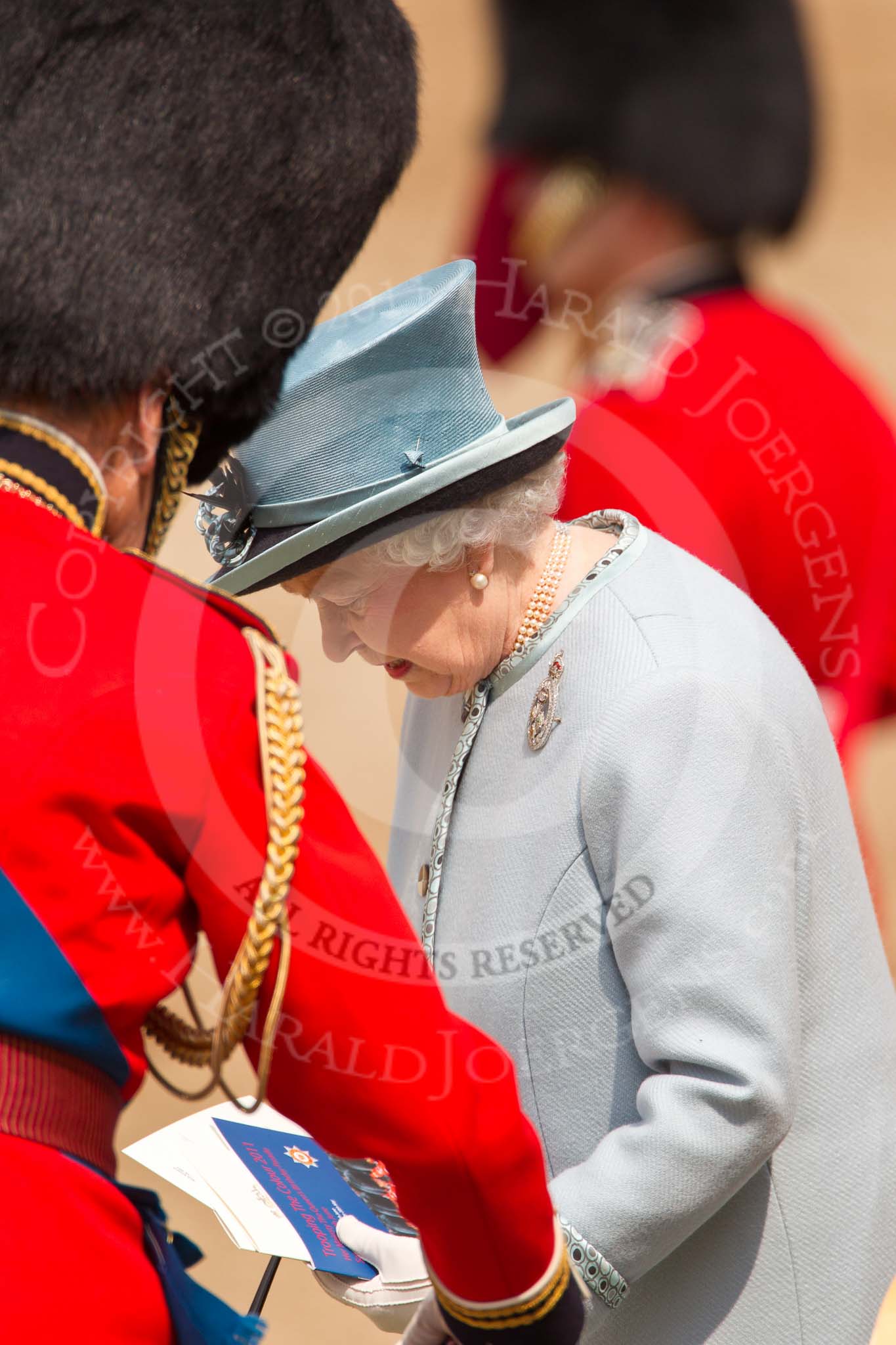 Trooping the Colour 2011: HM The Queen, back at the saluting base after the Inspection of the Line, about to take a seat, with the official programme of the parade in her hand..
Horse Guards Parade, Westminster,
London SW1,
Greater London,
United Kingdom,
on 11 June 2011 at 11:08, image #173