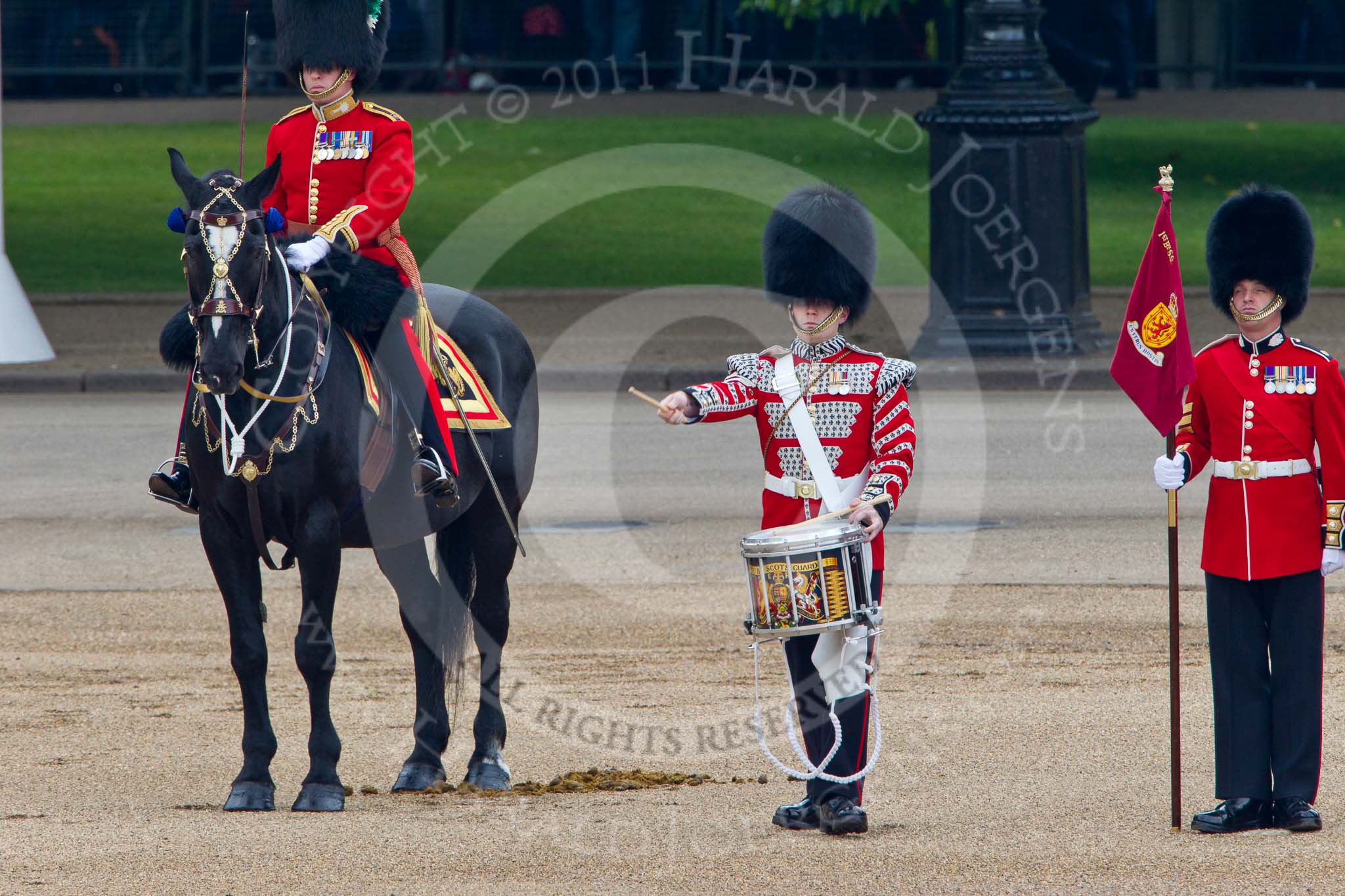 Trooping the Colour 2011: The Lone Drummer, Lance Corporal Gordon Prescott, just leaving the line, marching to a position at the right of the Escort to the Colour, where he will bear the 'drummers call', which will start the next phase of the parade.
On horseback the Major of the Parade, Major Benedict Peter Norman Ramsay, Welsh Guards..
Horse Guards Parade, Westminster,
London SW1,
Greater London,
United Kingdom,
on 11 June 2011 at 11:16, image #194