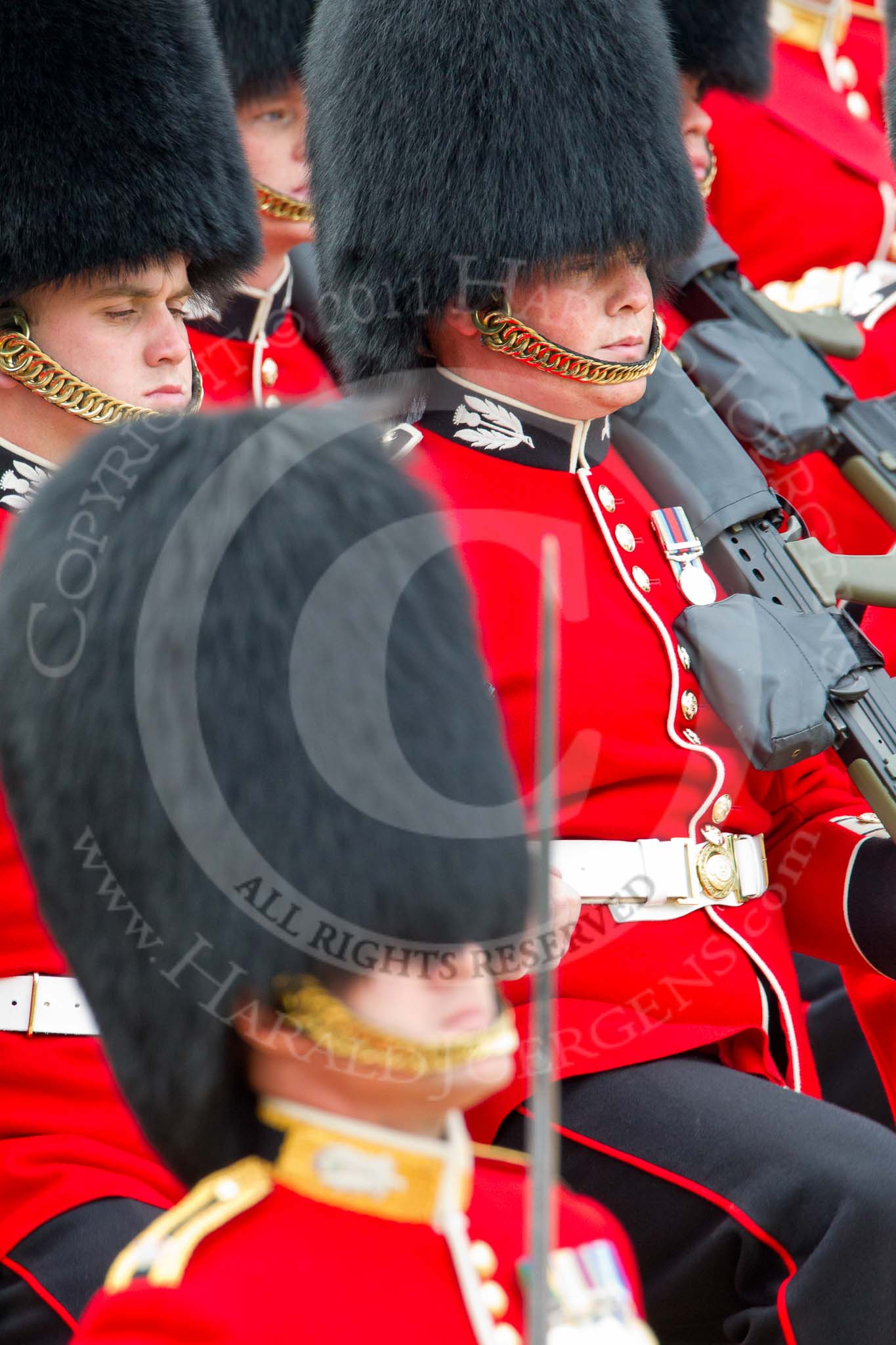 Trooping the Colour 2011: Young guardsmen from No. 1 Guard, 1st Battalion Scots Guards, the Escort for the Colour, marching. The guardsman in the middle is wearing his Afghanistan Service Medal. In front, and out of focus, Major Roderick Shannon, commanding the Escort..
Horse Guards Parade, Westminster,
London SW1,
Greater London,
United Kingdom,
on 11 June 2011 at 11:36, image #235