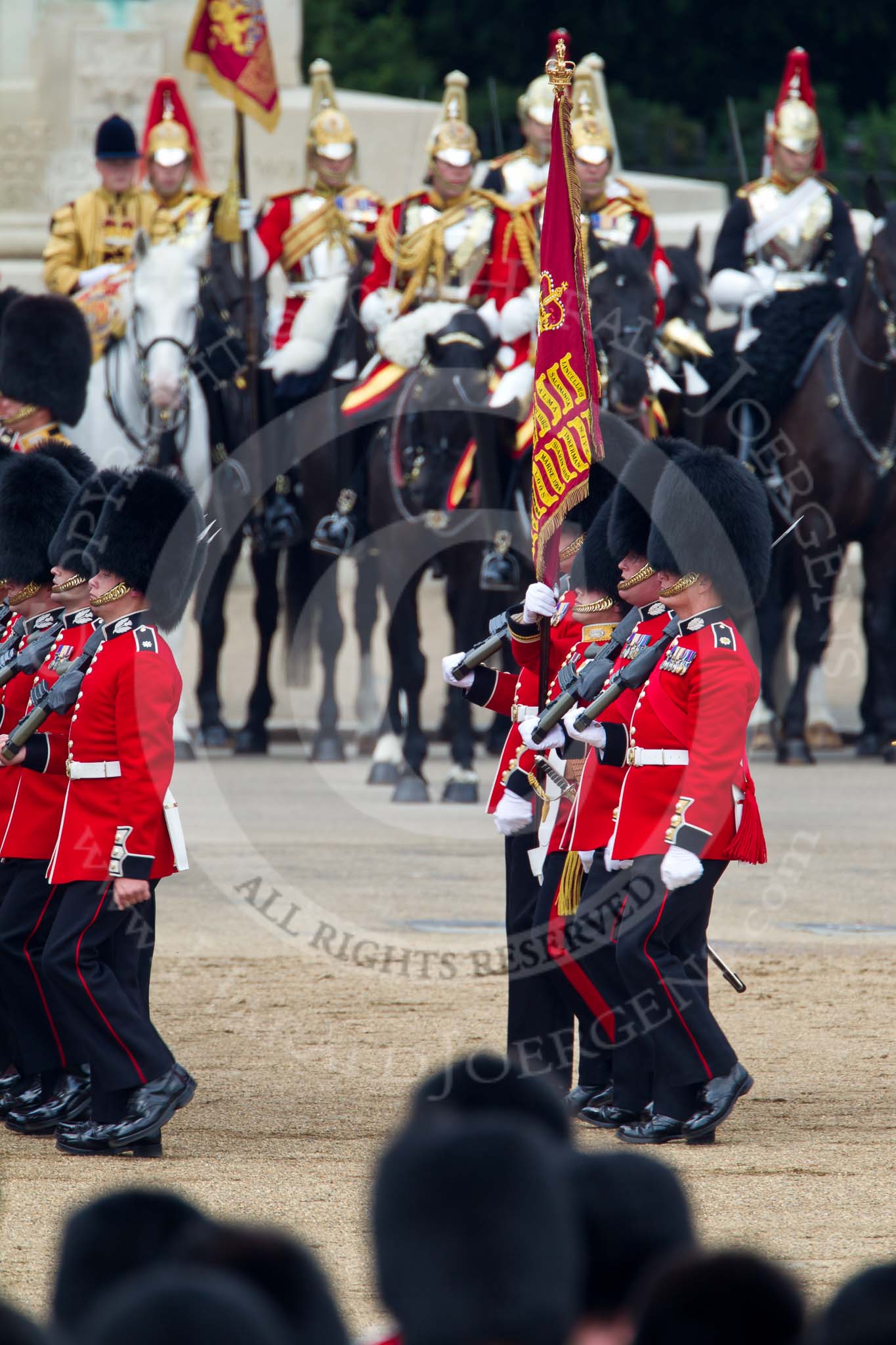 Trooping the Colour 2011: The Escort to the Colour. Carrying the flag in his white colour belt the ensign, Lieutenant Tom Ogilvy, and to his left, The Sergeant of the Ecort to the Colour, Colour Sergeant Chris Millin..
Horse Guards Parade, Westminster,
London SW1,
Greater London,
United Kingdom,
on 11 June 2011 at 11:43, image #270