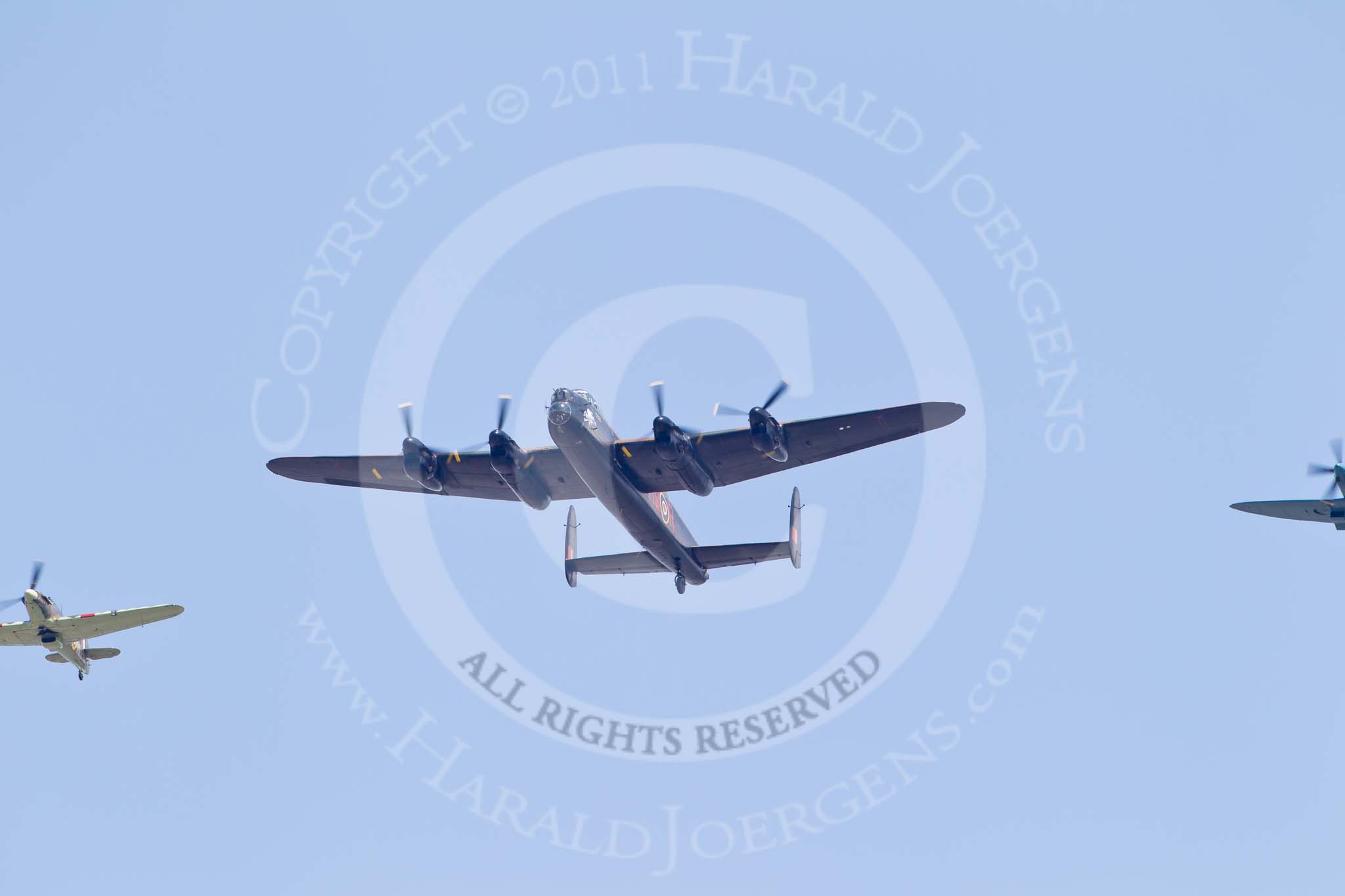 Photo 110611_130032_1D4_6691HaraldJoergens_ Trooping the Colour 2011: RAF Battle of Britain Memorial Flight, consisting of a Lancaster, a Spitfire and a Hurricane provided by RAF Coningsby, taking part in the flypast over Buckingham Palace at the end of Trooping The Colour 2011..
Horse Guards Parade, Westminster,
London SW1,
Greater London,
United Kingdom,
on 11 June 2011 at 13:00, image #444