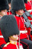 Trooping the Colour 2011: Young guardsmen from No. 1 Guard, 1st Battalion Scots Guards, the Escort for the Colour, marching. The guardsman in the middle is wearing his Afghanistan Service Medal. In front, and out of focus, Major Roderick Shannon, commanding the Escort..
Horse Guards Parade, Westminster,
London SW1,
Greater London,
United Kingdom,
on 11 June 2011 at 11:36, image #235