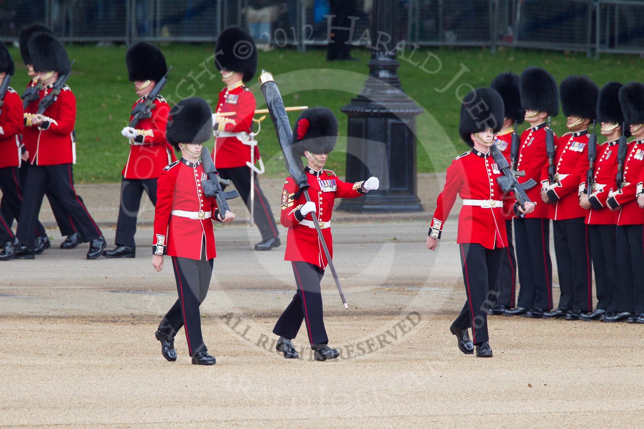 Trooping the Colour 2012: Colour Sereant Paul Baines, carrying the Colour, with the two sentries, guardsmen Gareth Effrington and Kyle Dunbarth. Paul Baines is wearing the Military Cross he received for bravery whilst serving in Afghanistan..
Horse Guards Parade, Westminster,
London SW1,

United Kingdom,
on 16 June 2012 at 10:30, image #70