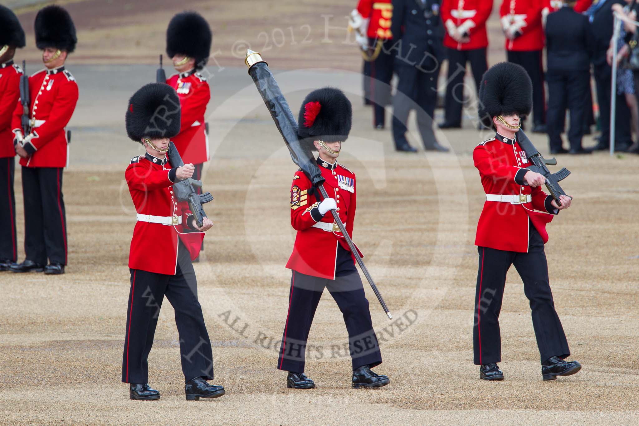 Trooping the Colour 2012: Colour Sereant Paul Baines, carrying the Colour, with the two sentries, guardsmen Gareth Effrington and Kyle Dunbarth. Paul Baines is wearing the Military Cross he received for bravery whilst serving in Afghanistan..
Horse Guards Parade, Westminster,
London SW1,

United Kingdom,
on 16 June 2012 at 10:31, image #71