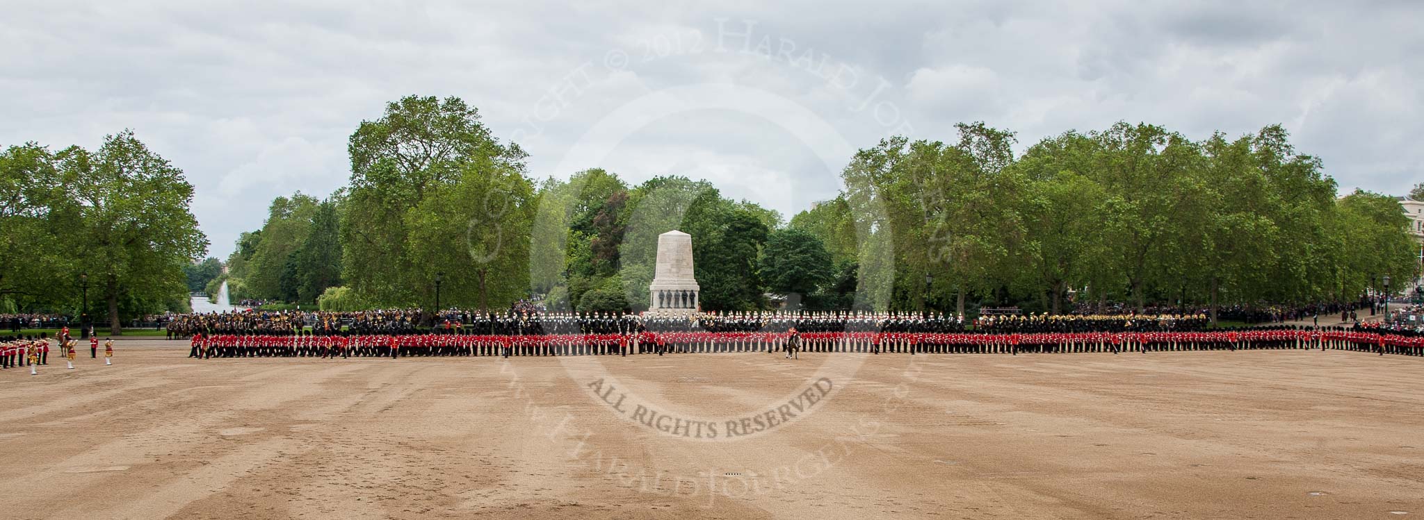 Trooping the Colour 2012: Horse Guards Parade whist the Colour is trooped. In the centre te Guards Memorial, on the left, on front if the lake and fountain in St. James's Park, No. 1 Guard, the Escort to the Colour. On the very left the Massed Bands..
Horse Guards Parade, Westminster,
London SW1,

United Kingdom,
on 16 June 2012 at 11:28, image #358