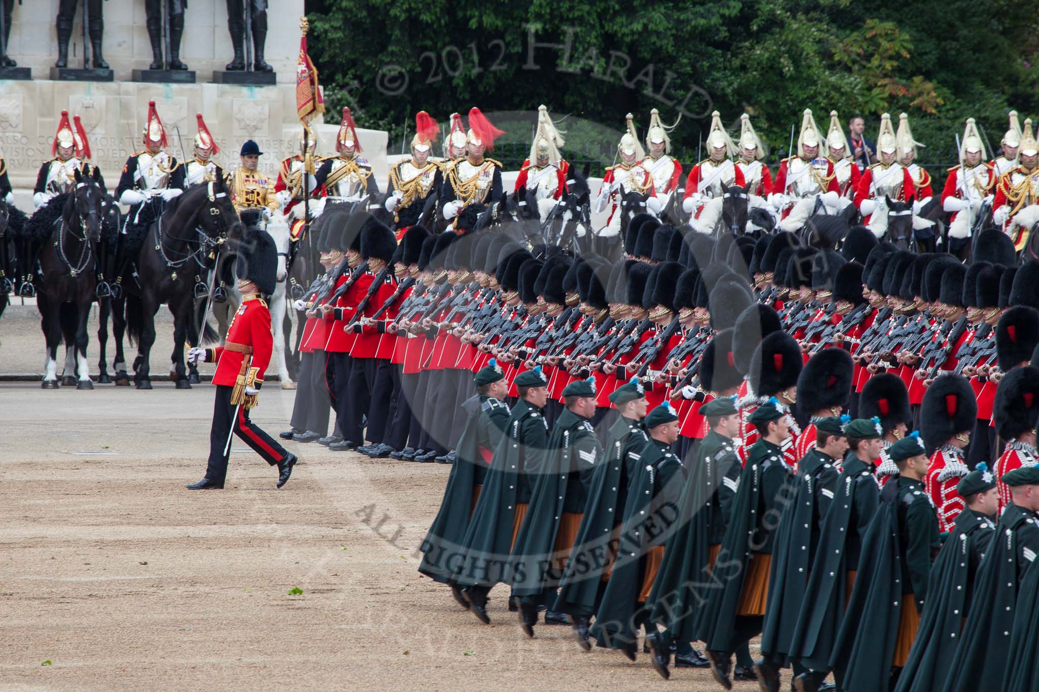 Trooping the Colour 2012: Elements of the parade - the Household Cavalry in front of the Guards Memorial, with the trumpeter, standard bearer, and standard coverer in the middle, in front of them No. 6 Guard, F Company Scots Guards, during the March Past, and in the foreground the Massed Bands..
Horse Guards Parade, Westminster,
London SW1,

United Kingdom,
on 16 June 2012 at 11:33, image #387