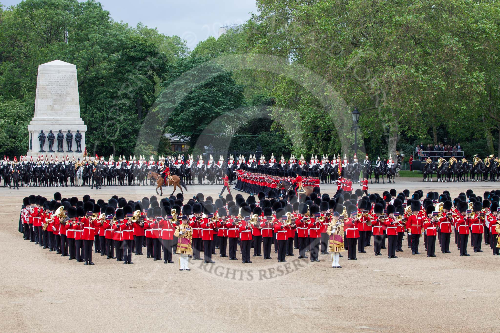 Trooping the Colour 2012: The March Past: No. 1 Guard (Escort to the Colour), 1st Battalion Coldstream Guards, marching between the Household Cavalry on the St.  James's Park side of Horse Guards Parade, and the Massed Bands in the cenre. Riding in front is the Major of the Parade..
Horse Guards Parade, Westminster,
London SW1,

United Kingdom,
on 16 June 2012 at 11:42, image #467