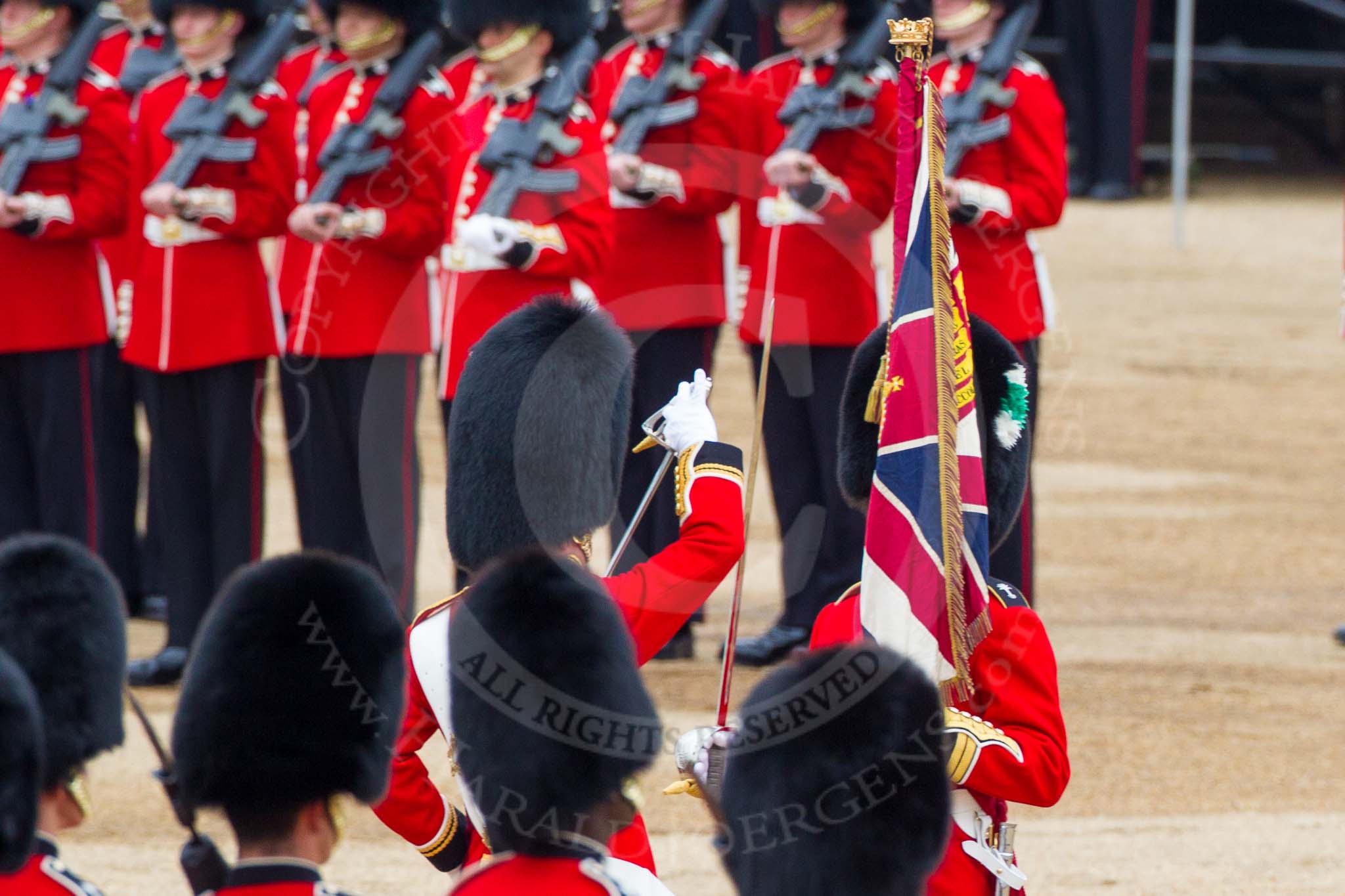 Major General's Review 2013: The Regimental Sergeant Major, WO1 Martin Topps, Welsh Guards  presents the Colour to the Ensign, Second Lieutenant Joel Dinwiddle, who sheathes the sword..
Horse Guards Parade, Westminster,
London SW1,

United Kingdom,
on 01 June 2013 at 11:19, image #400