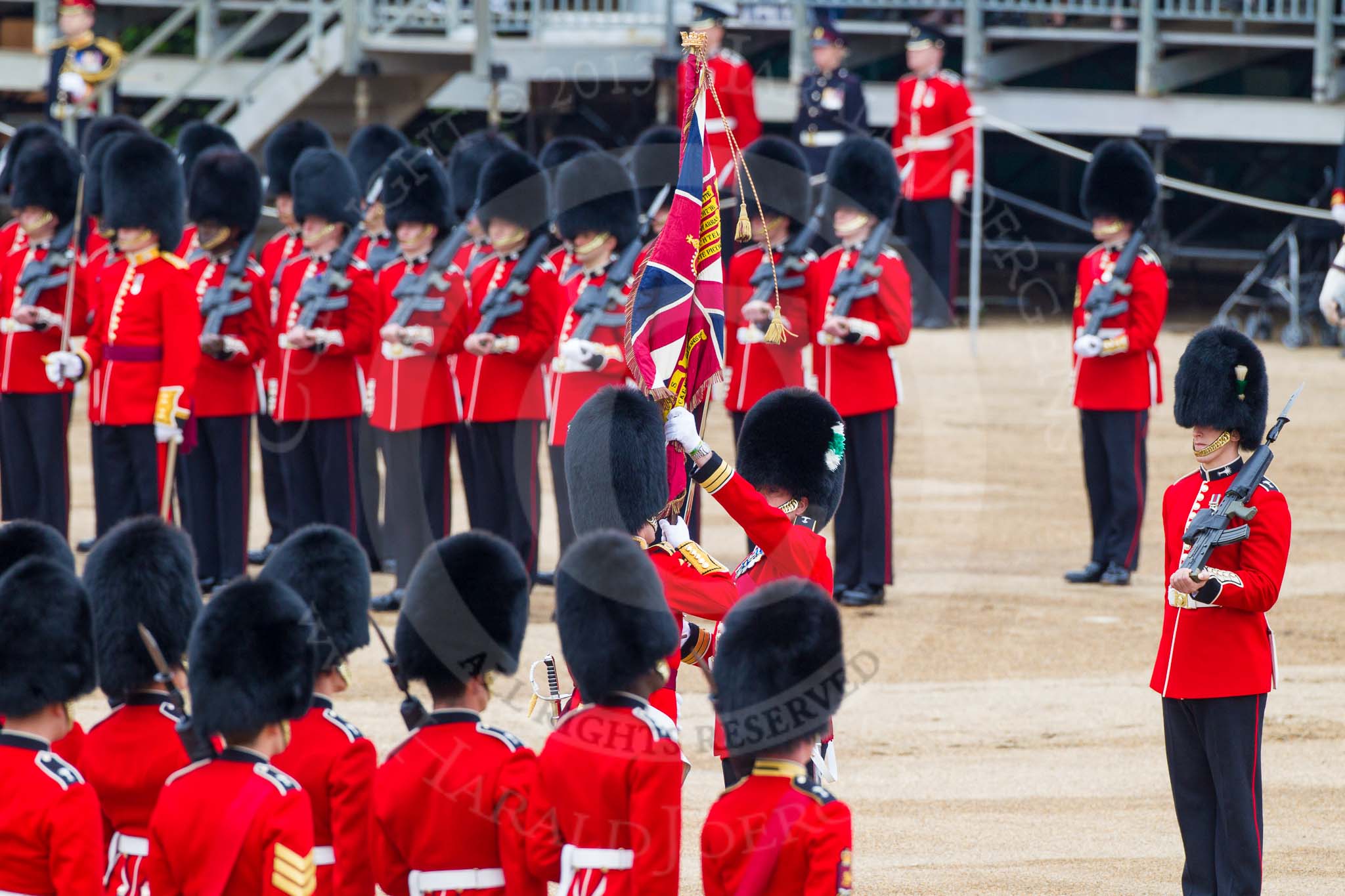 Major General's Review 2013: The Ensign, Second Lieutenant Joel Dinwiddle, takes posession of the Colour from the Regimental Sergeant Major, WO1 Martin Topps, Welsh Guards..
Horse Guards Parade, Westminster,
London SW1,

United Kingdom,
on 01 June 2013 at 11:19, image #401