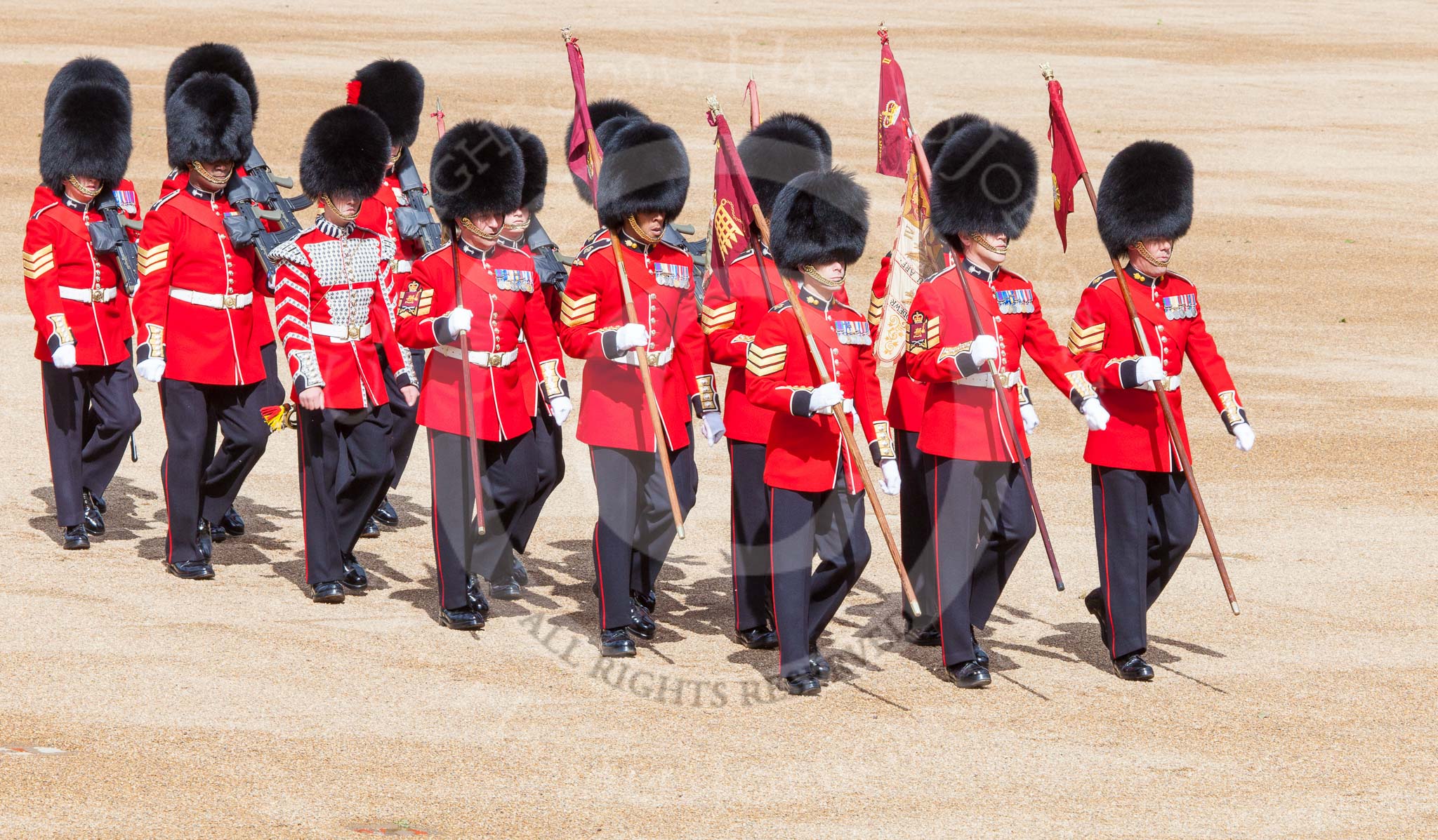 Trooping the Colour 2013: The 'Keepers of the Ground', guardsmen bearing marker flags for their respective regiments, marching towards Horse Guards Arch. Image #26, 15 June 2013 09:54 Horse Guards Parade, London, UK