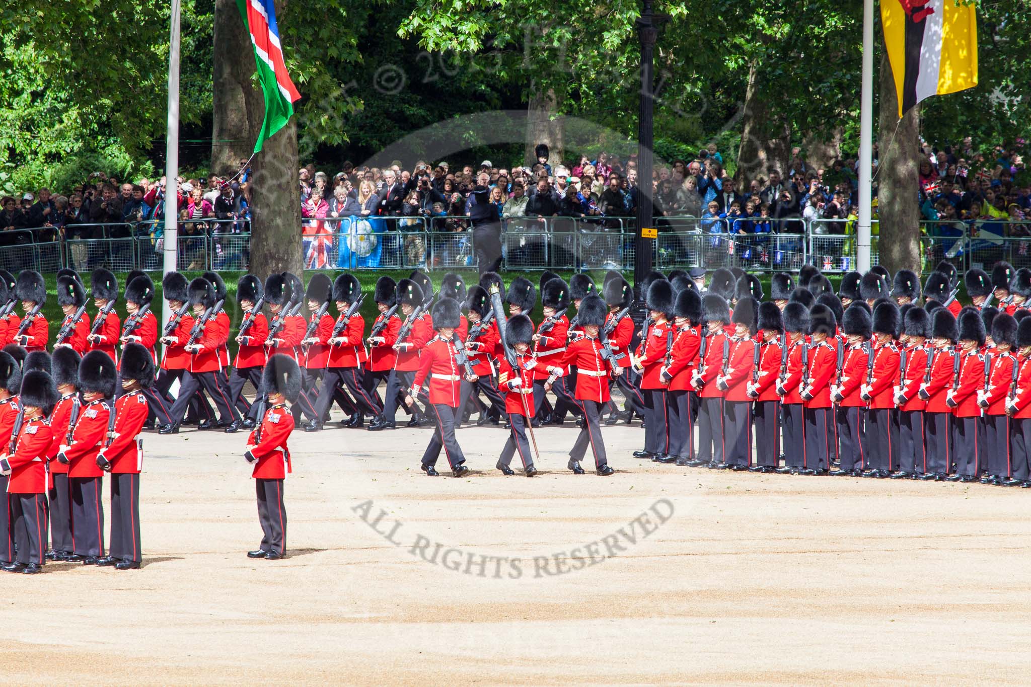 Trooping the Colour 2013: The Colour Party breaks away from No. 1 Guard - Colour Sergeant R J Heath, carrying the Colour and two sentries marching to their position on Horse Guards Parade. Image #106, 15 June 2013 10:30 Horse Guards Parade, London, UK