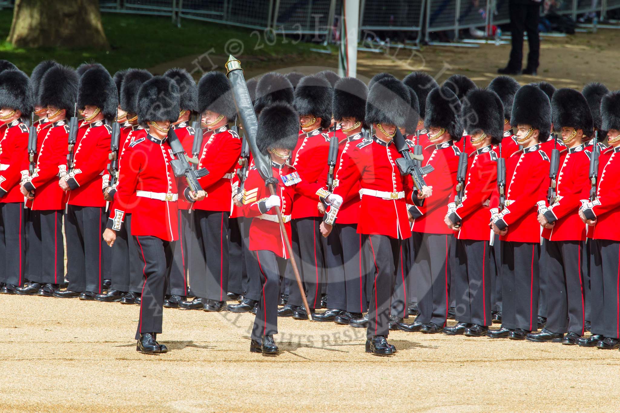 Trooping the Colour 2013: The Colour Party marches along No. 6 Guard - Colour Sergeant R J Heath, Welsh Guards, carrying the Colour, and two sentries marching to their position on Horse Guards Parade. Image #108, 15 June 2013 10:31 Horse Guards Parade, London, UK