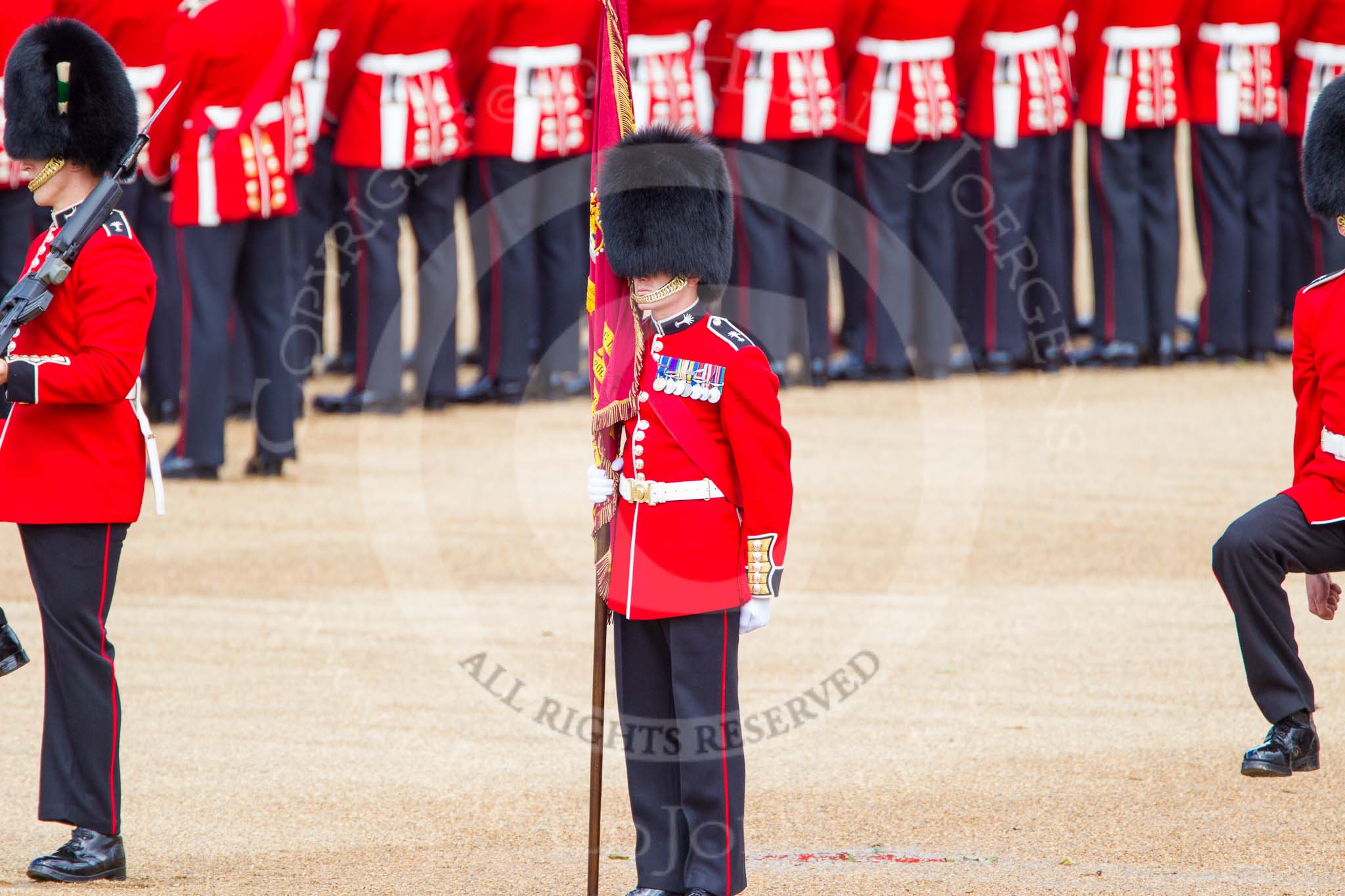 Trooping the Colour 2013: The Escort Party, Colour Sergeant R J Heath, holding the Colour,  Welsh Guards, and the two sentries. Image #123, 15 June 2013 10:34 Horse Guards Parade, London, UK