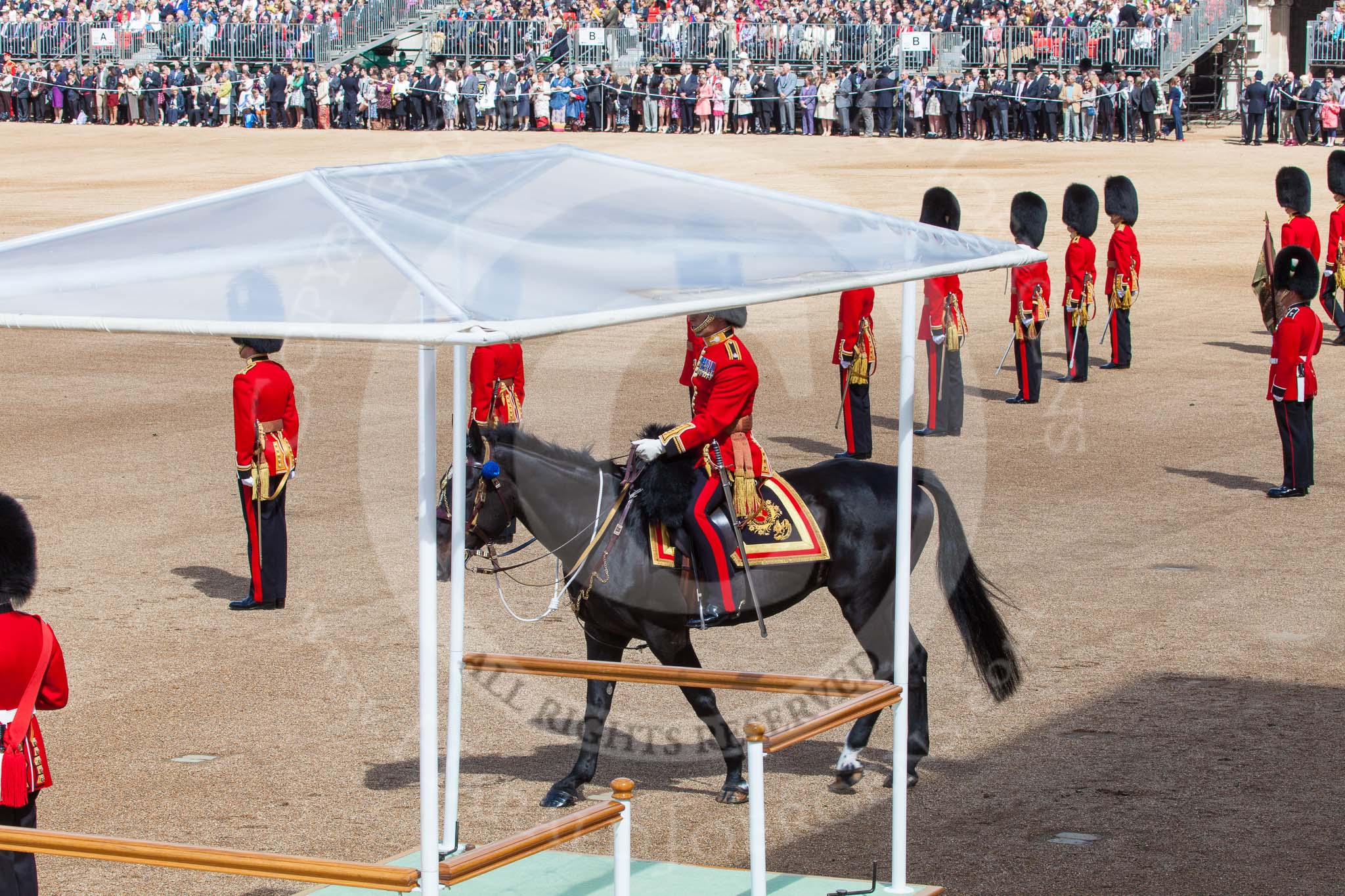 Trooping the Colour 2013: The eighteen Officers, three for each Guard, await the order to take post in front of their respective Guards, whilst the Major of the Parade, Major H G C Bettinson, Welsh Guards, rides onto Horse Guards Parade. Image #139, 15 June 2013 10:37 Horse Guards Parade, London, UK