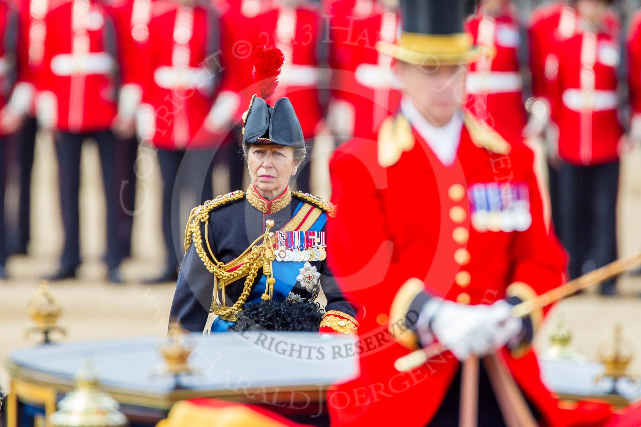 Trooping the Colour 2013: HRH The Princess Royal, Colonel The Blues and Royals (Royal Horse Guards and 1st Dragoons), following the Glass Coach after the Inspection of the Line.  She apprears surrounded by scarlet uniforms..
Horse Guards Parade, Westminster,
London SW1,

United Kingdom,
on 15 June 2013 at 11:07, image #372