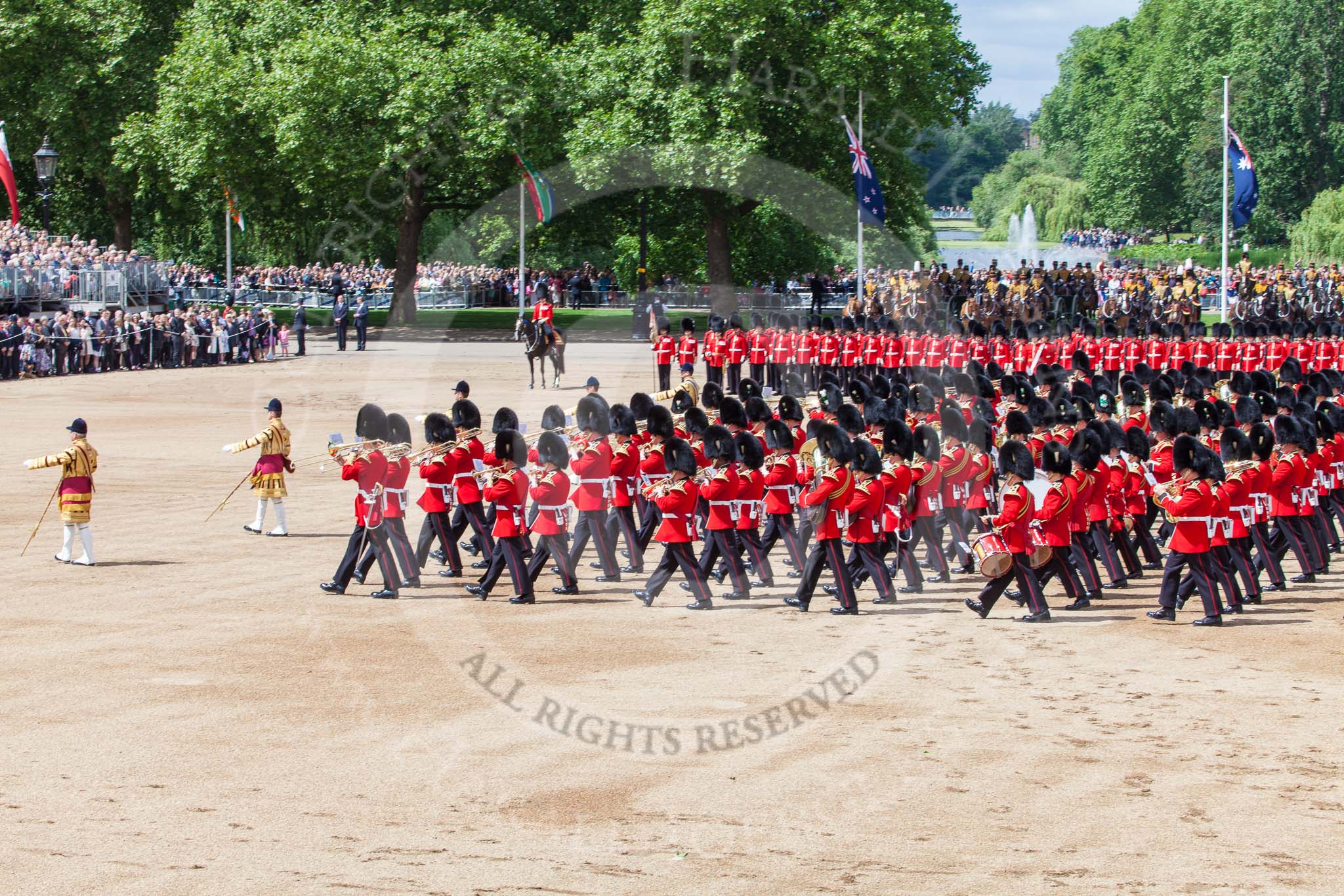 Trooping the Colour 2013: The Massed Band Troop - the final stages of the countermarch. No. 1 Guard, the Escort for the Colour, is to the right of the musicians. Behind them The King's Troop Royal Horse Artillery and St James's Park Lake, next to them, on horseback, the Major of the Parade. Image #414, 15 June 2013 11:13 Horse Guards Parade, London, UK
