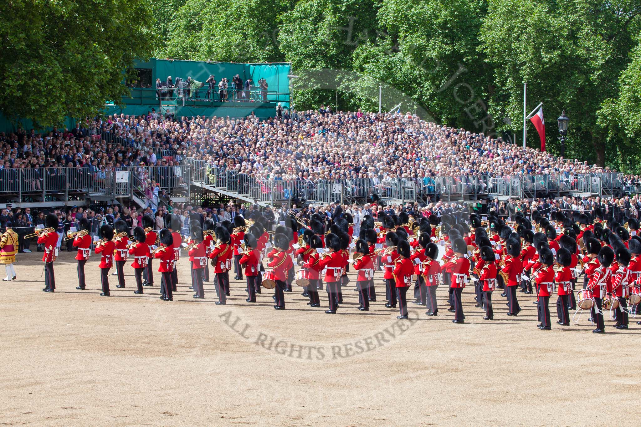Trooping the Colour 2013: The Massed Band Troop - the countermarch is about to end. In the top right of the image one of the press stands used by the BBC for their live broadcast, with Huw Edwards and his team in the green box next to the press stand. Image #418, 15 June 2013 11:14 Horse Guards Parade, London, UK