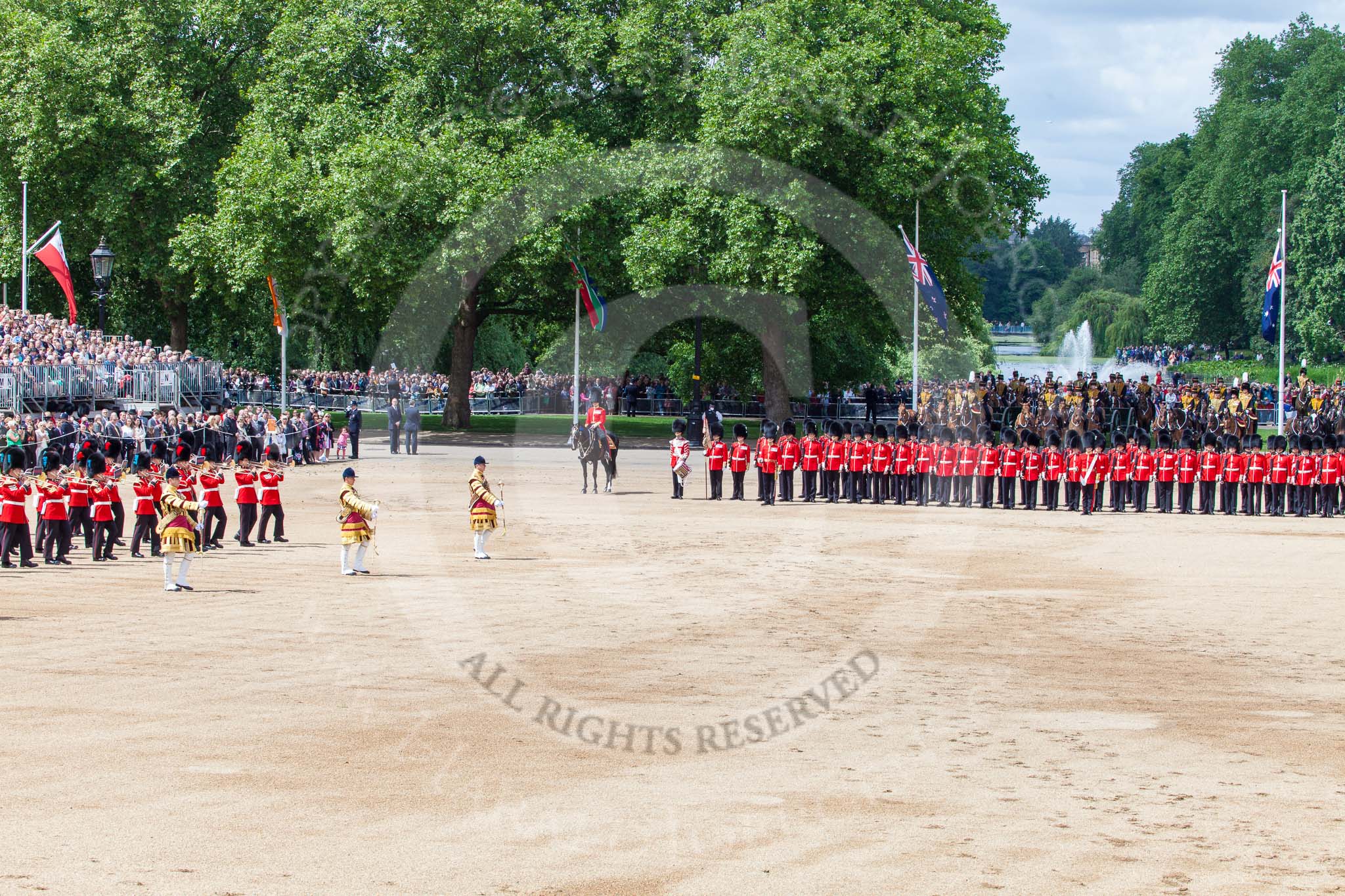Trooping the Colour 2013: The end of the Massed Bands Troop - the Lone Drummer has taken his position between the Major of the Parade and No. 1 Guard. Behind No. 1 Guard the King's Troop Royal Horse Artillery and St James's Park Lake. Image #420, 15 June 2013 11:14 Horse Guards Parade, London, UK