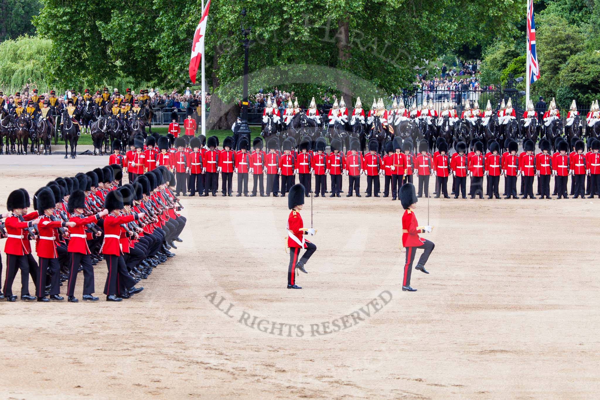 Trooping the Colour 2013: The men of No. 1 Guard (Escort for the Colour),1st Battalion Welsh Guards are moving into a new formation, facing the Coloir Party on the other side of Horse Guards Parade. In front the Ensign, Second Lieutenant Joel Dinwiddle, and the Subaltern, Captain F O Lloyd-George. Image #441, 15 June 2013 11:18 Horse Guards Parade, London, UK
