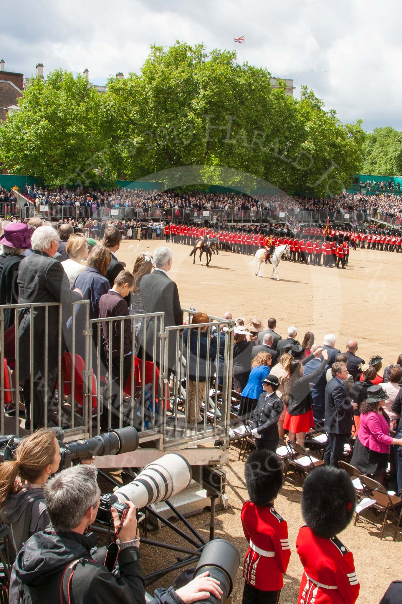 Trooping the Colour 2013: Wide angle view from the press stand, including spectators andphotographers,  during the March Past. Image #534, 15 June 2013 11:34 Horse Guards Parade, London, UK