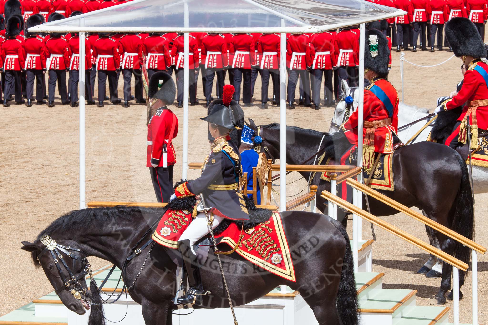 Trooping the Colour 2013: The Royal Colonels, and HRH The Duke of Kent and HM The Queen on the dais, whilst the Field Offcer salutes during the March past. Image #564, 15 June 2013 11:39 Horse Guards Parade, London, UK