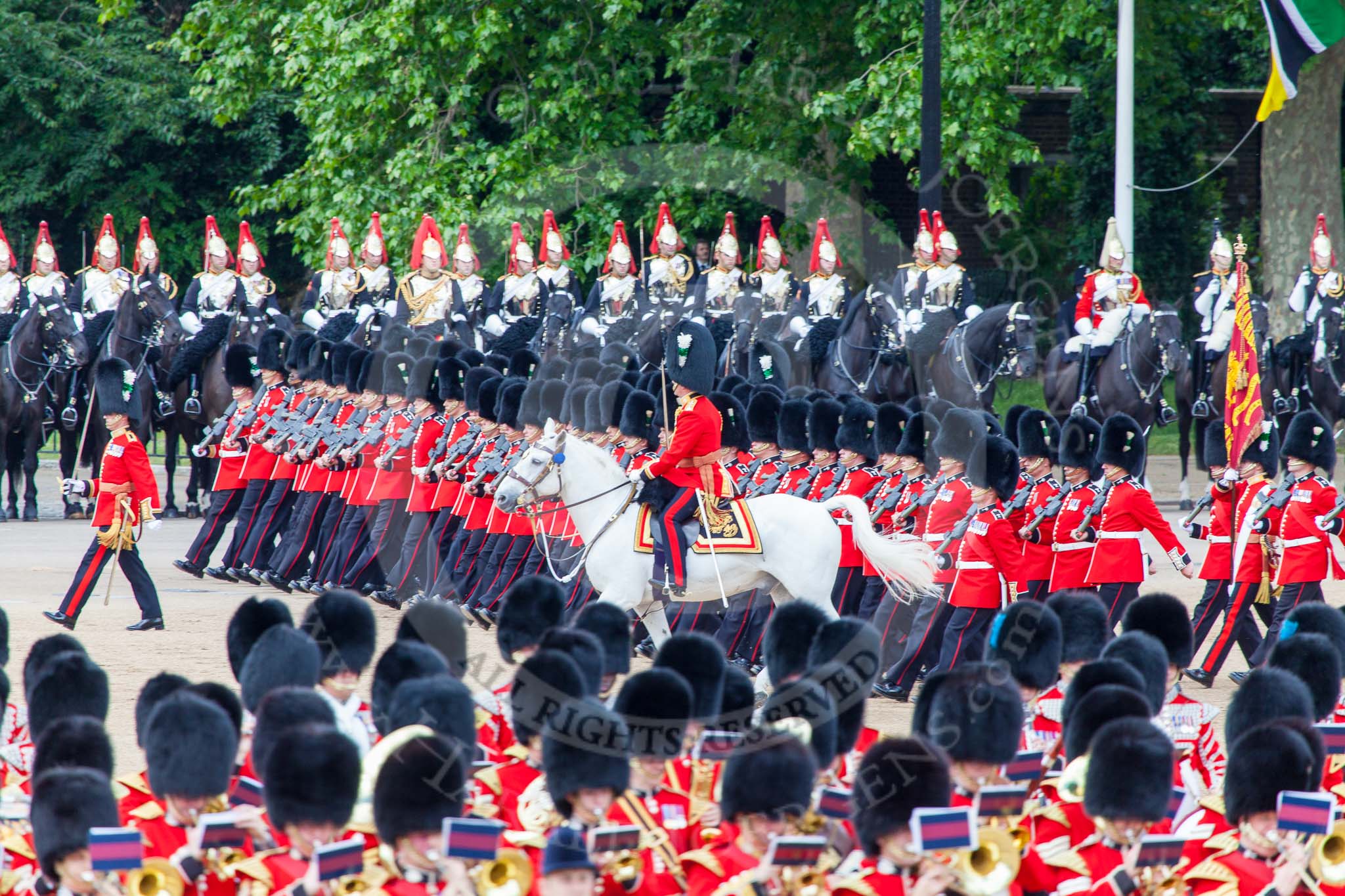 Trooping the Colour 2013: No. 1 Guard (Escort for the Colour),1st Battalion Welsh Guards, at the beginning of the March Past in Quick Time. Behind them the Mounted Bands of the Household Cavalry. The Field Officer returns to the head of the march past. Image #581, 15 June 2013 11:42 Horse Guards Parade, London, UK