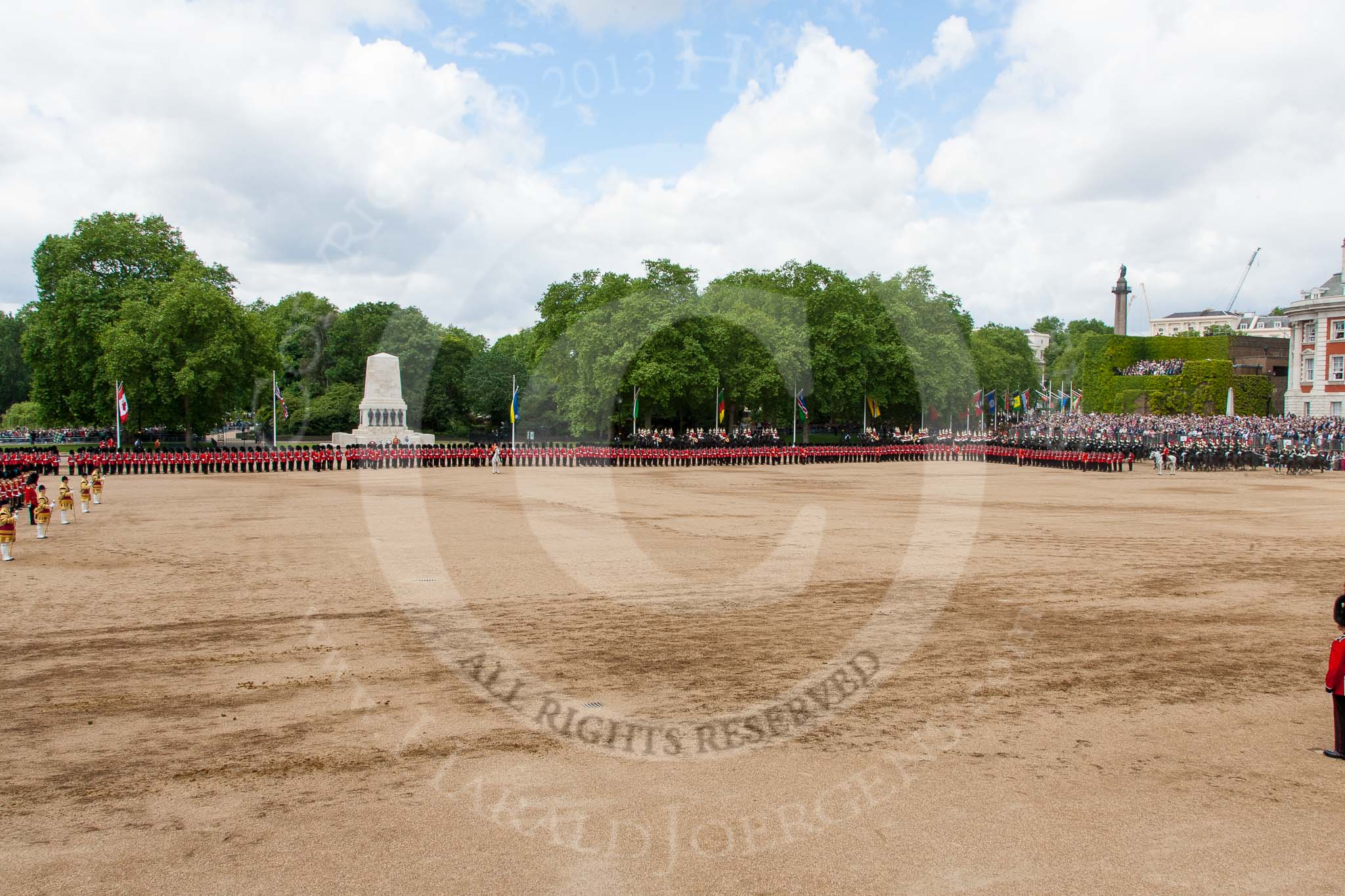 Trooping the Colour 2013: A wide angle overview of Horse Guards Parade after the Ride Past. The Household Cavalry is returning to their initial positions below the flags, next to St James's Park. Image #755, 15 June 2013 12:00 Horse Guards Parade, London, UK