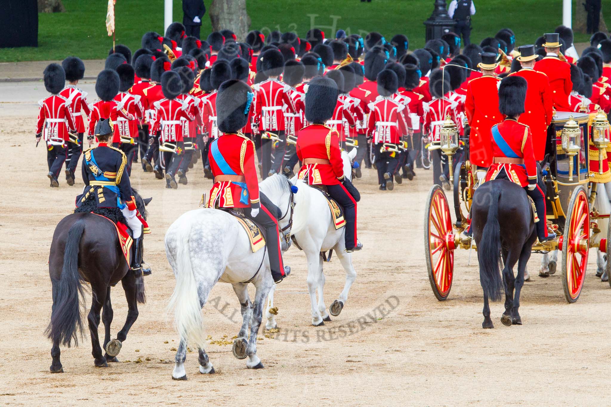 Trooping the Colour 2013: The March Off - the Massed Bands are leaving towards The Mall, followed by the glass coach accying HM The Queen and HRH The Duke of Kent. Behind the glass coach the Royal Colonels. Image #827, 15 June 2013 12:11 Horse Guards Parade, London, UK