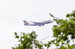 Trooping the Colour 2013: Minutes before the RAF flypast, a reminder that Westminster is within the approach to Heathrow Airport, here a British Airways 747 about to land. Image #879, 15 June 2013 12:50 Horse Guards Parade, London, UK