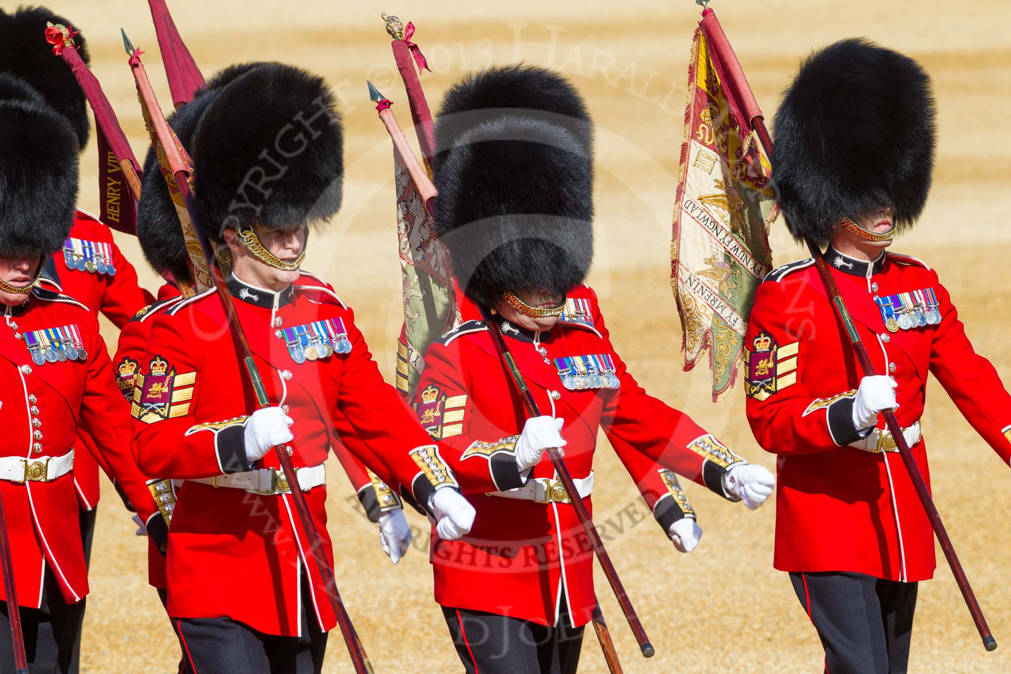 The 'Keepers of the Ground', guardsmen bearing marker flags for their respective regiments, marching towards Horse Guards Arch.