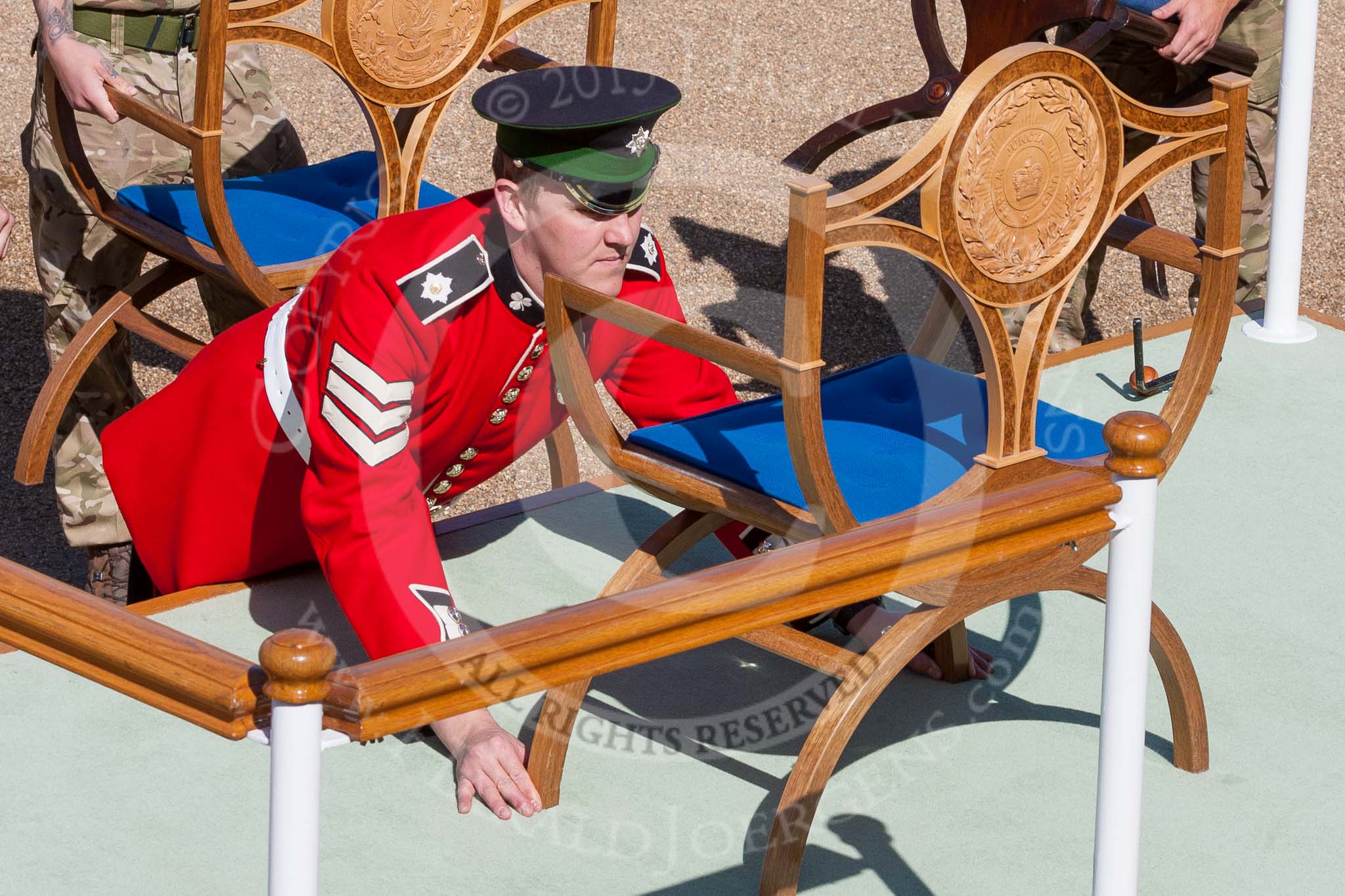 The Colonel's Review 2015: An Irish Guards sergeant makes precision adjustments to one of the chairs on the dais..
Horse Guards Parade, Westminster,
London,

United Kingdom,
on 06 June 2015 at 09:35, image #19