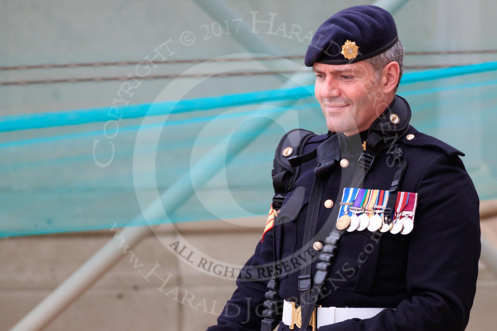 Army photographer in uniform, wearing his medals and cameras, at the Wolseley press stand before The Colonel's Review 2018 (final rehearsal for Trooping the Colour, The Queen's Birthday Parade)  at Horse Guards Parade, Westminster, London, 2 June 2018, 09:21.